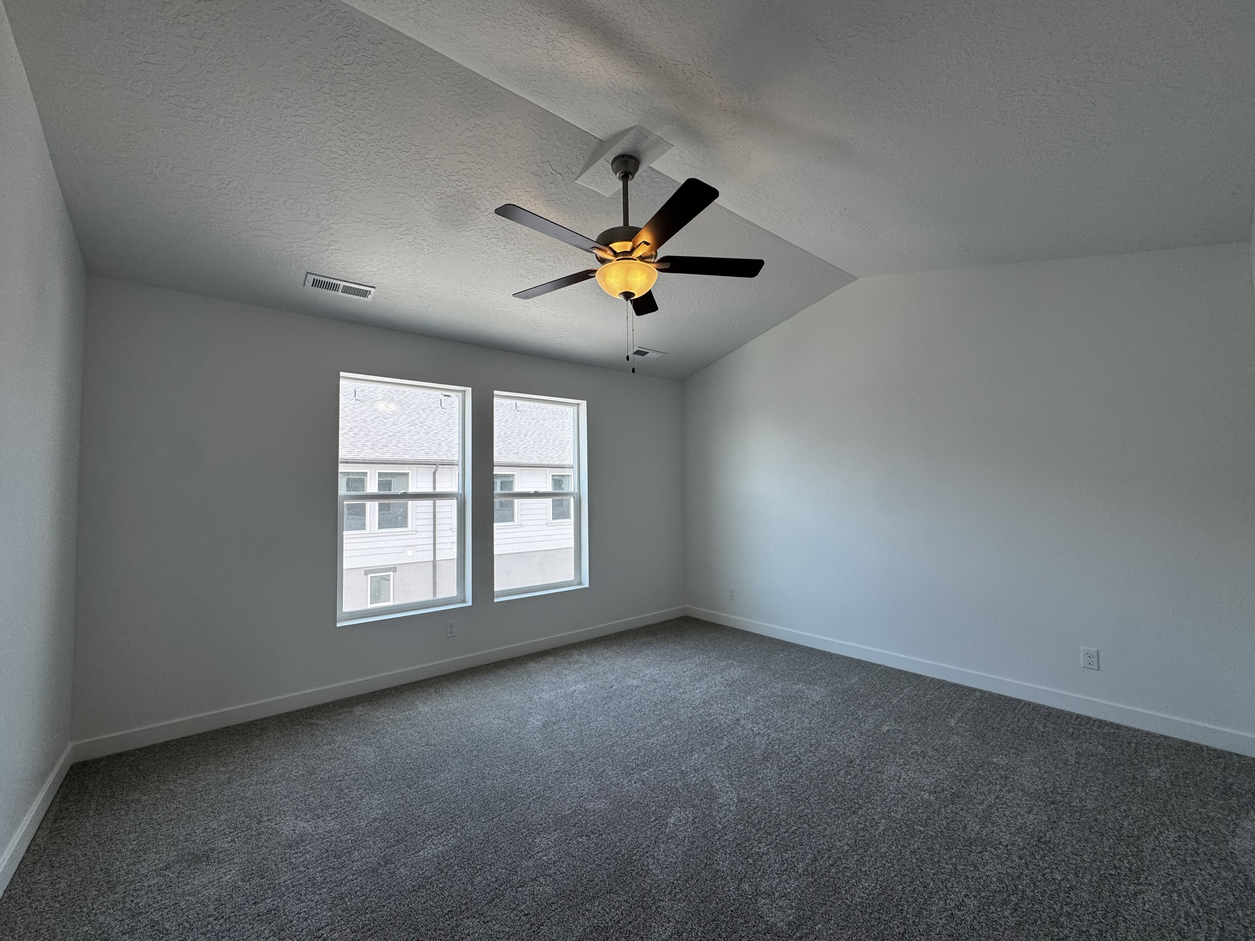 Vaulted ceiling featuring a ceiling fan with integrated lighting