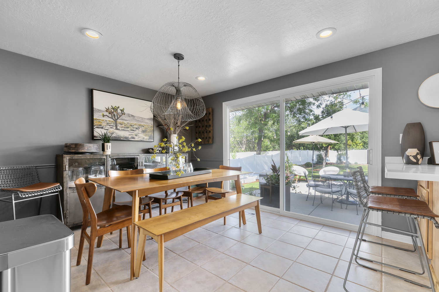 Dining area featuring tile flooring, recessed lighting, and a sliding glass door