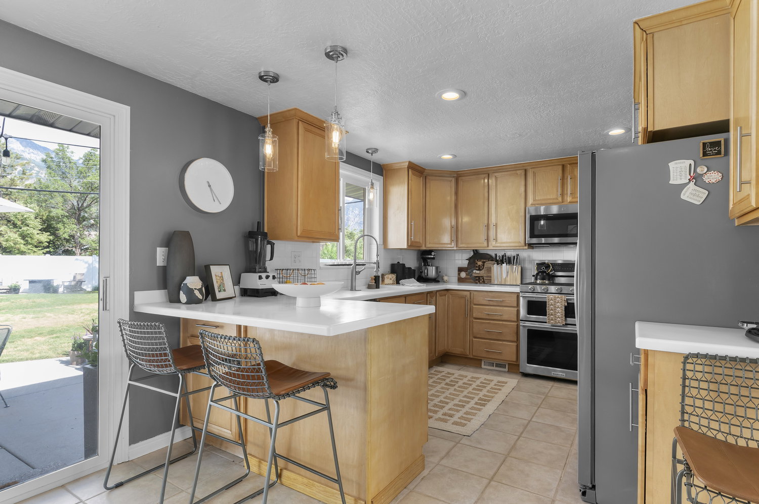 Kitchen featuring light wood cabinetry, stainless steel appliances, and white countertops