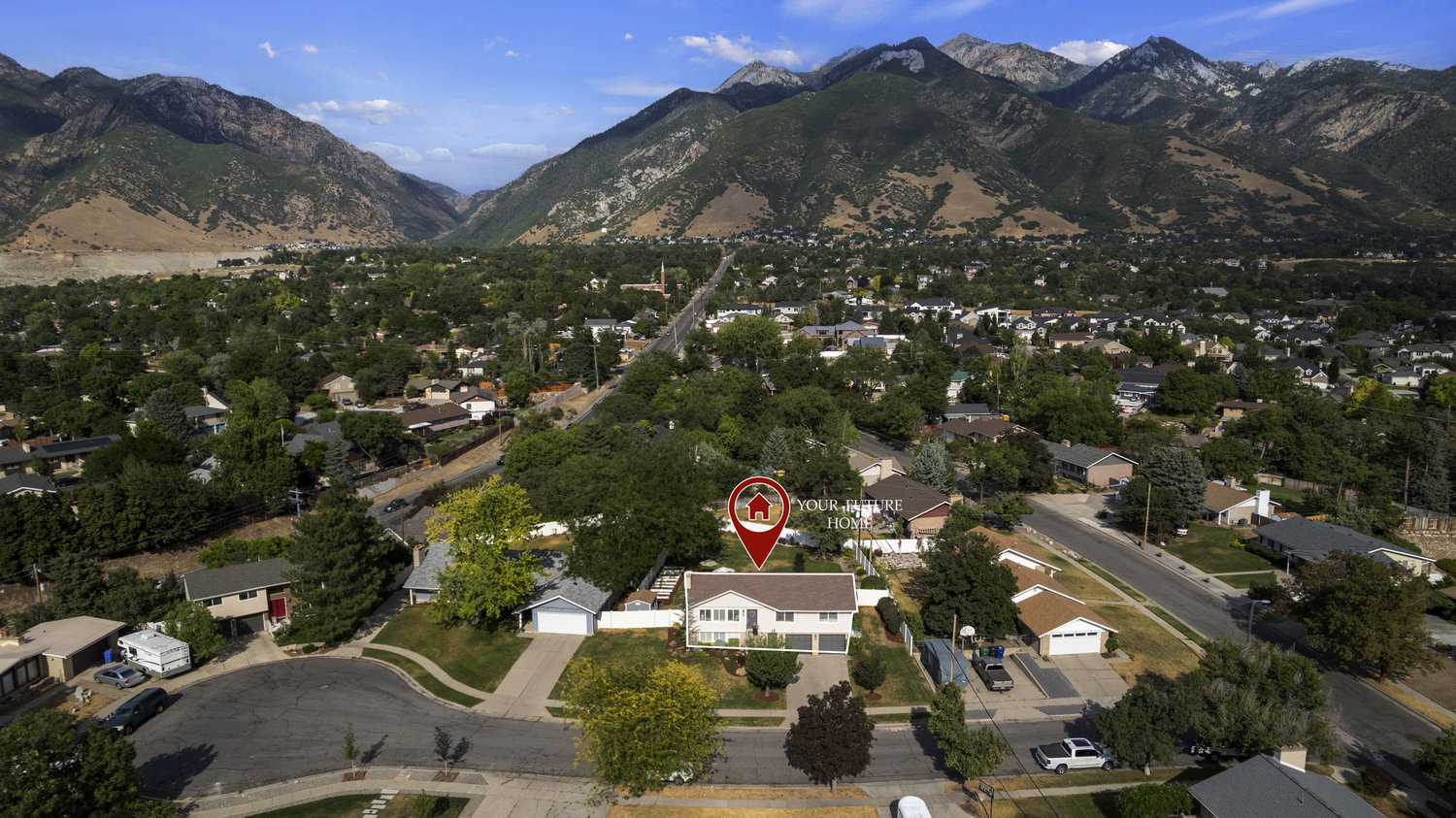 Aerial perspective showcasing a residential neighborhood with a prominent mountain backdrop