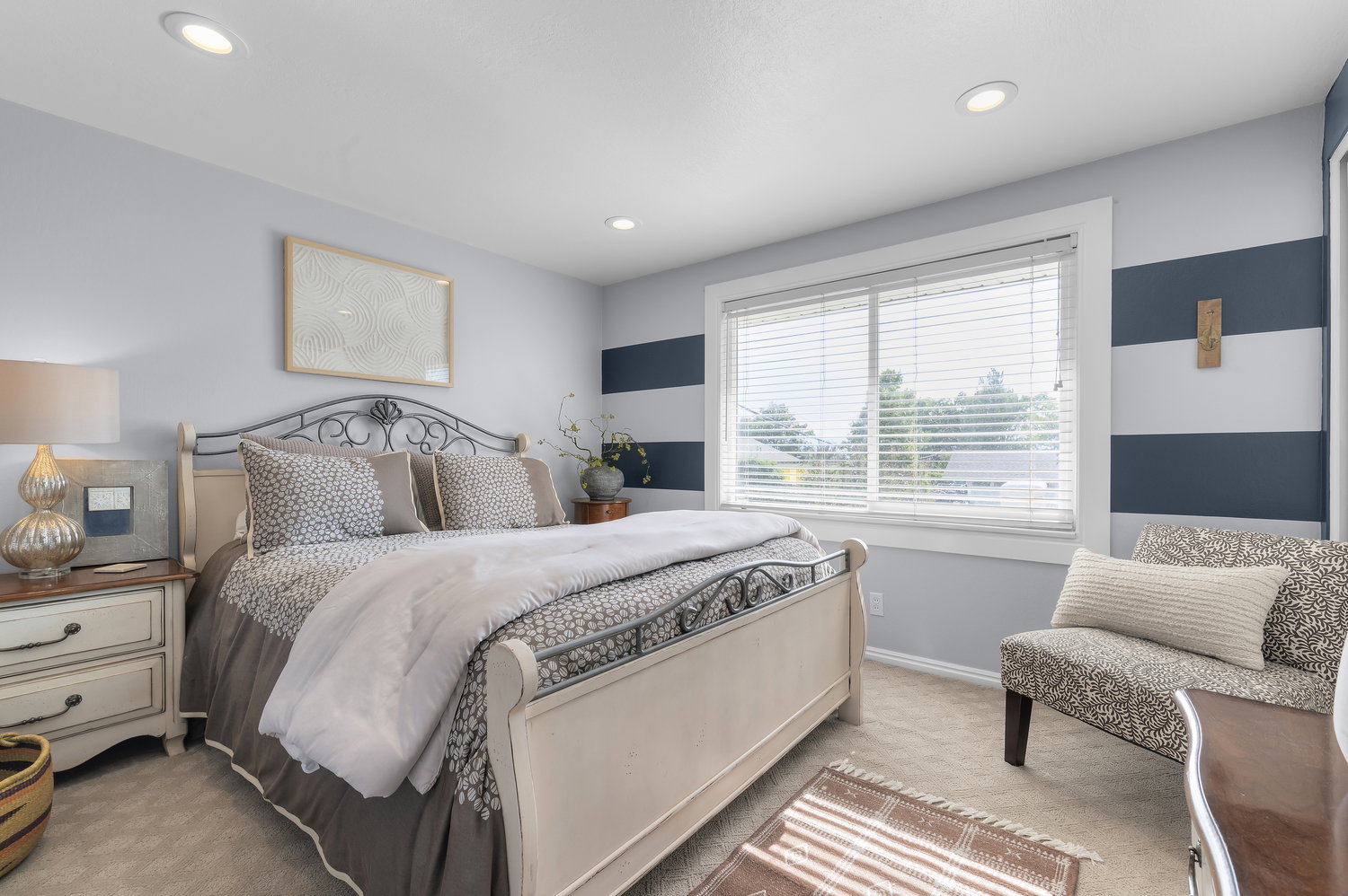 Carpeted bedroom featuring recessed lighting and a large window with white blinds