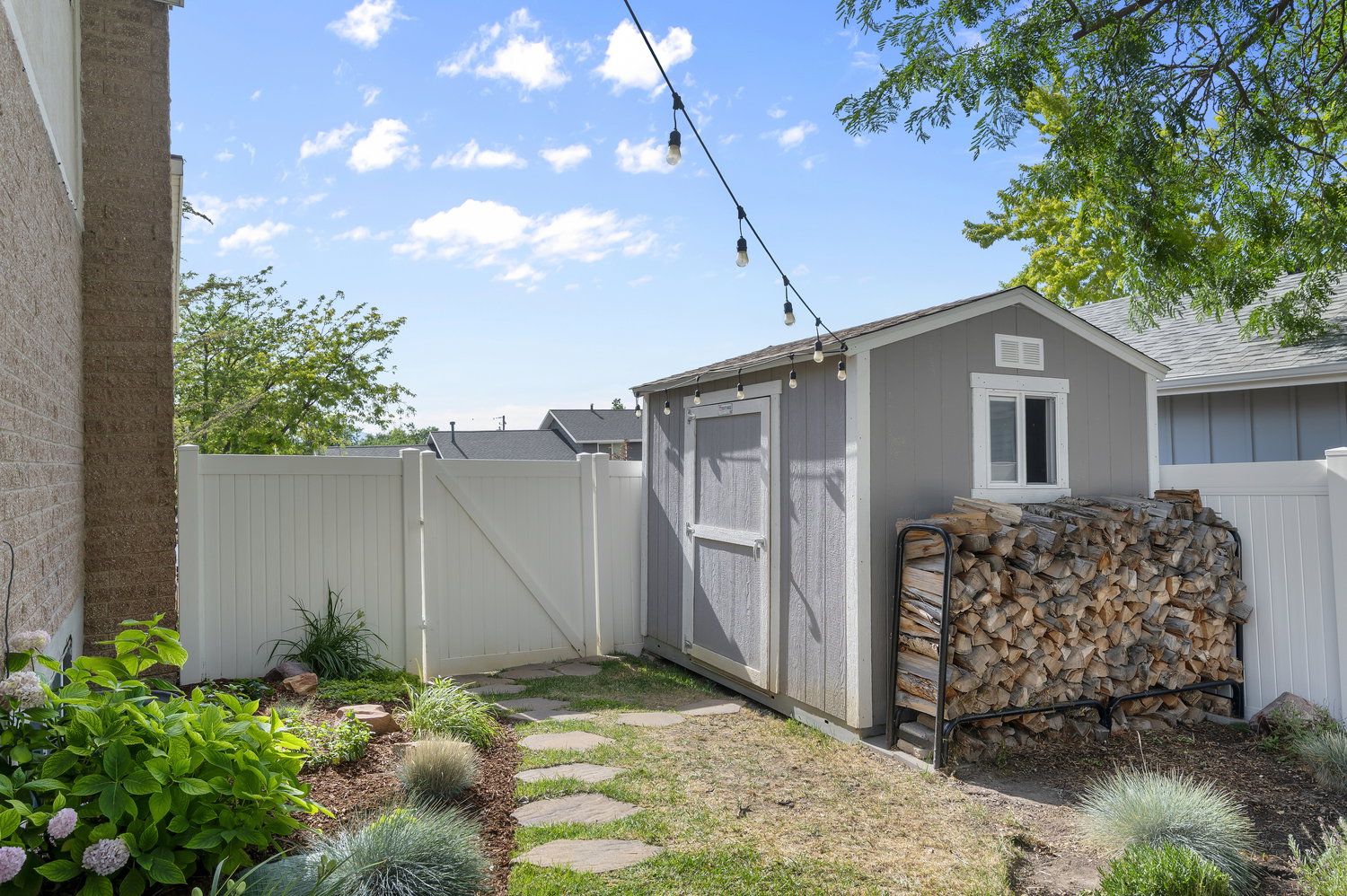 Outdoor storage shed with a window and a side door