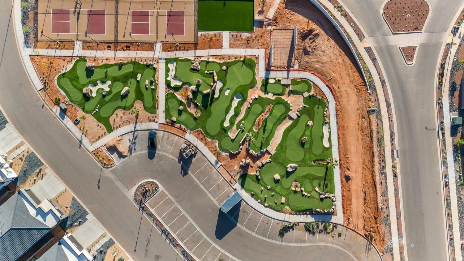 Miniature golf course featuring multiple greens and natural rock formations