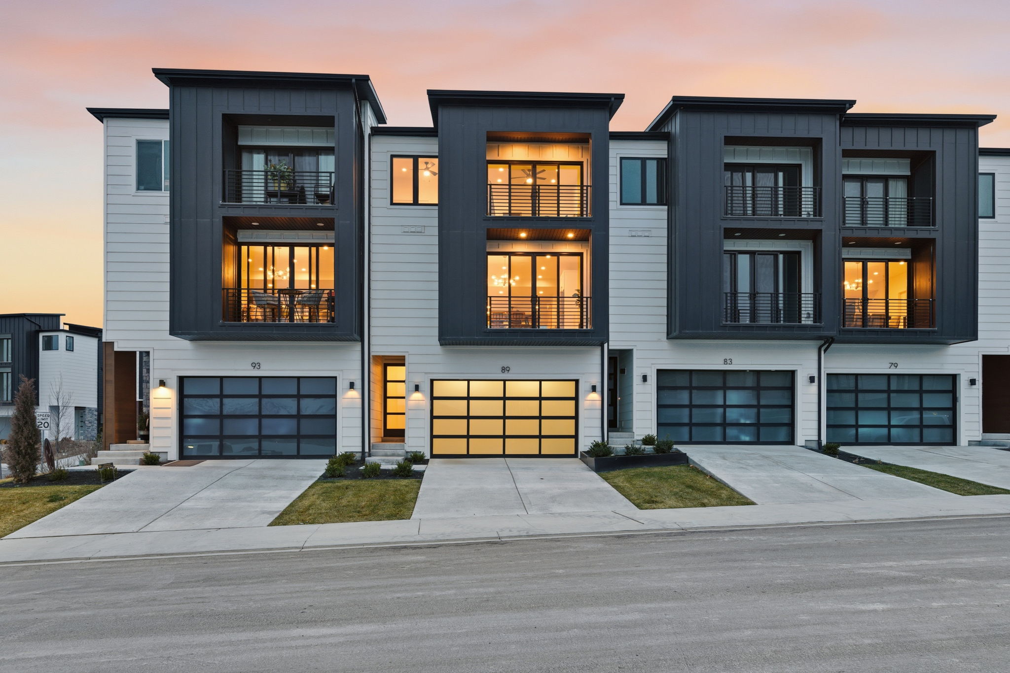 Contemporary townhome exteriors featuring clean lines and a striking dark and light panel facade
