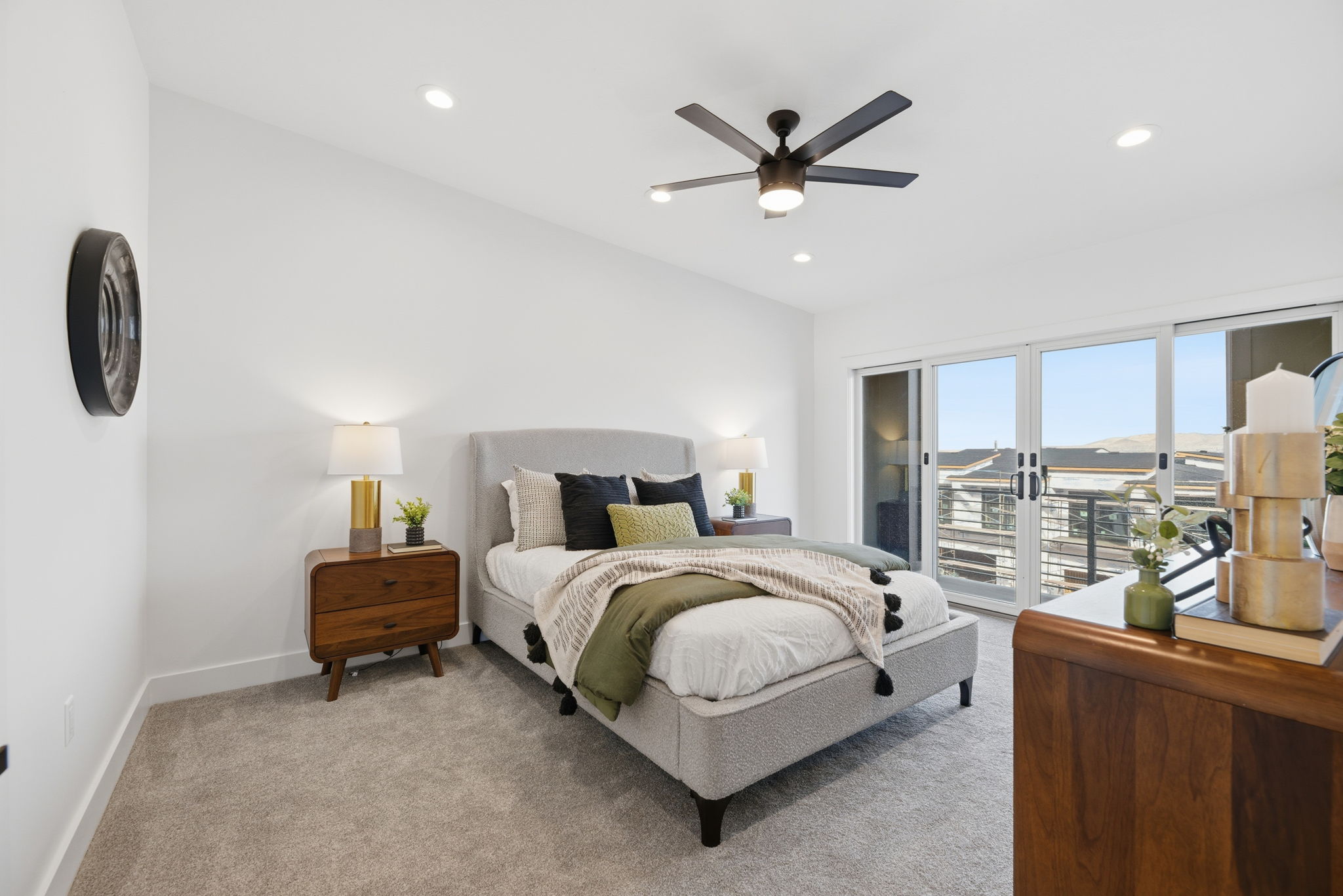 Carpeted room featuring a ceiling fan with integrated lighting, recessed lighting, and a large sliding glass door opening to an exterior space