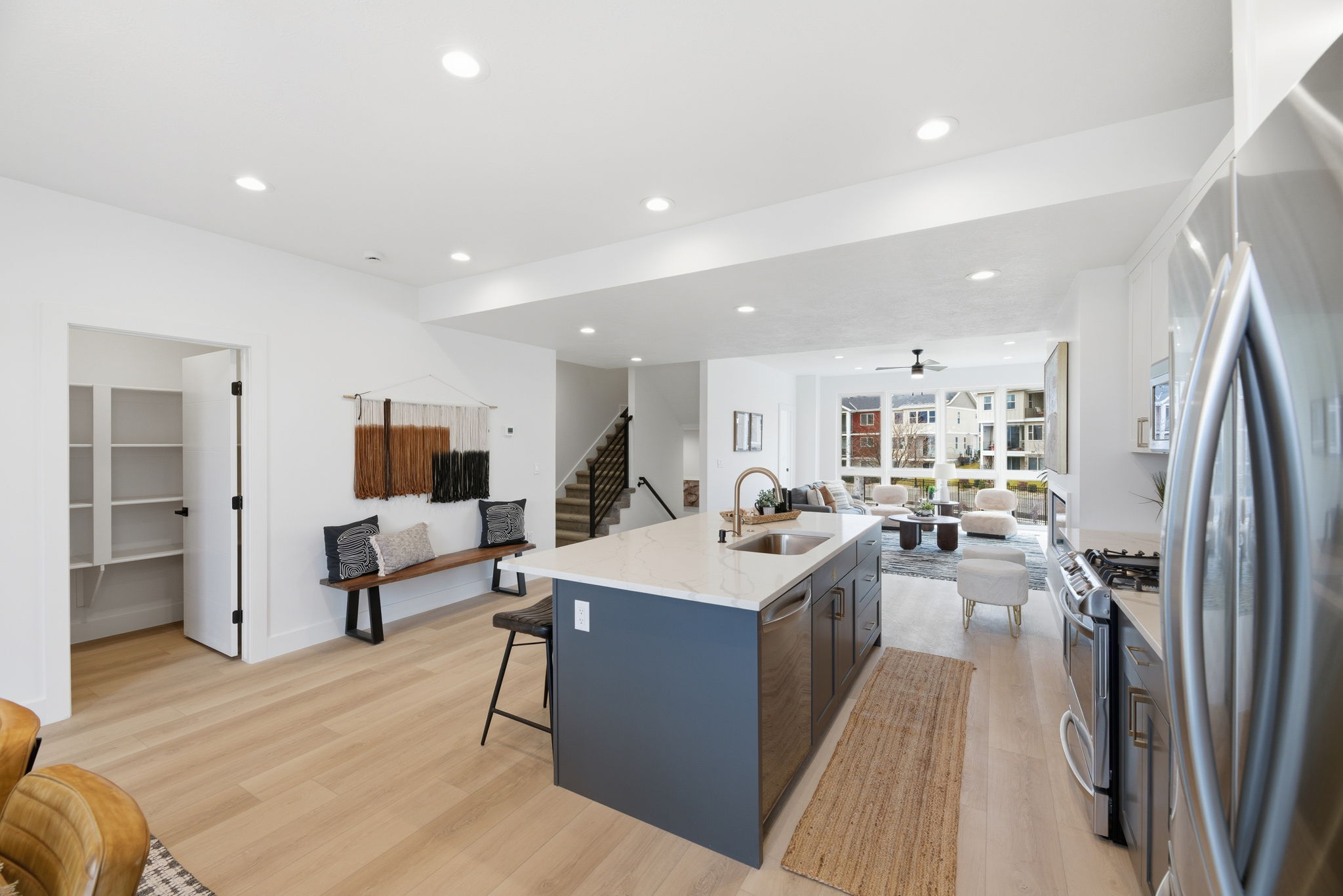 Open-concept living space with light wood-finish flooring