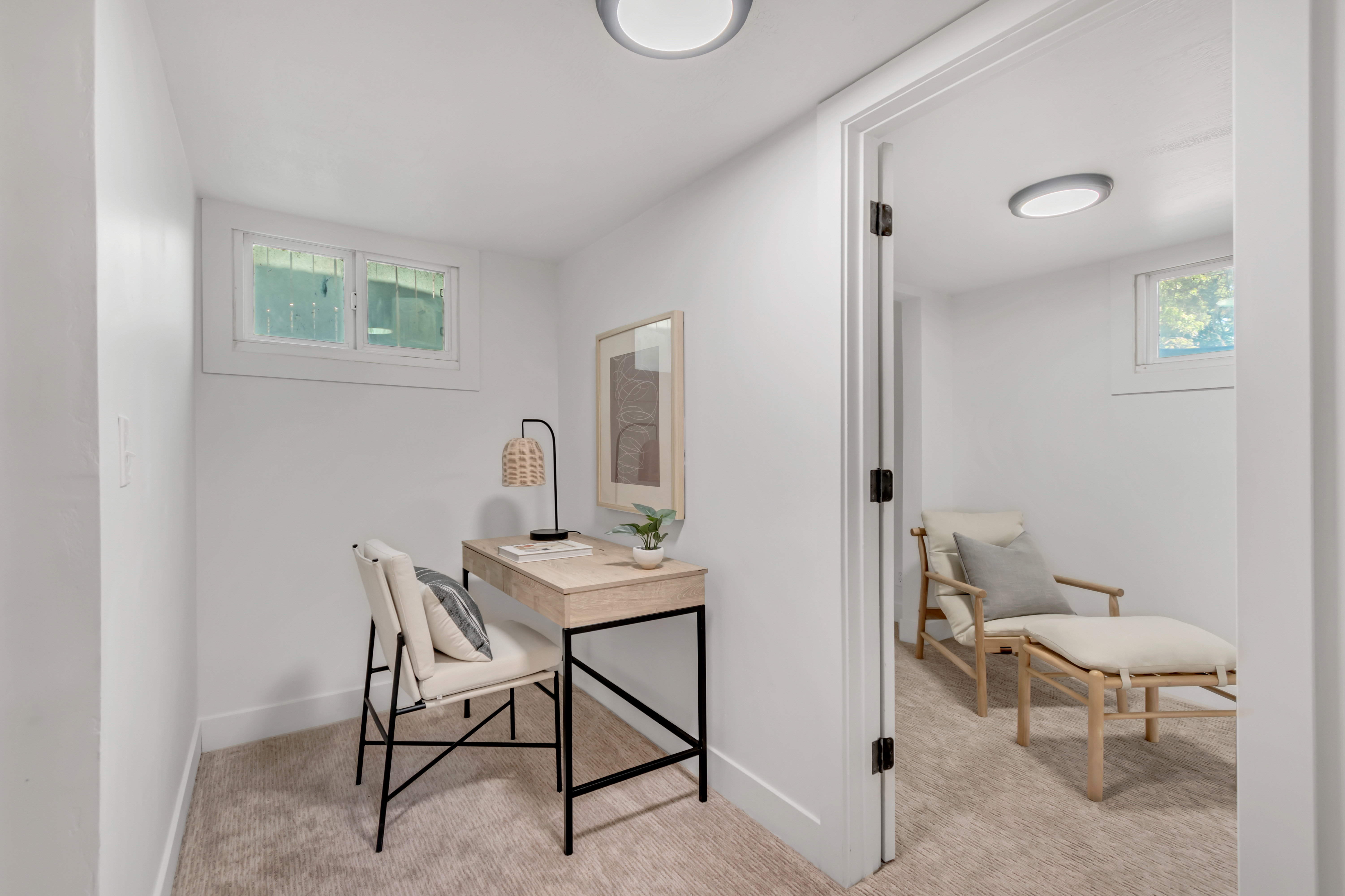 Bright interior room featuring white walls, recessed lighting, and a window with white trim