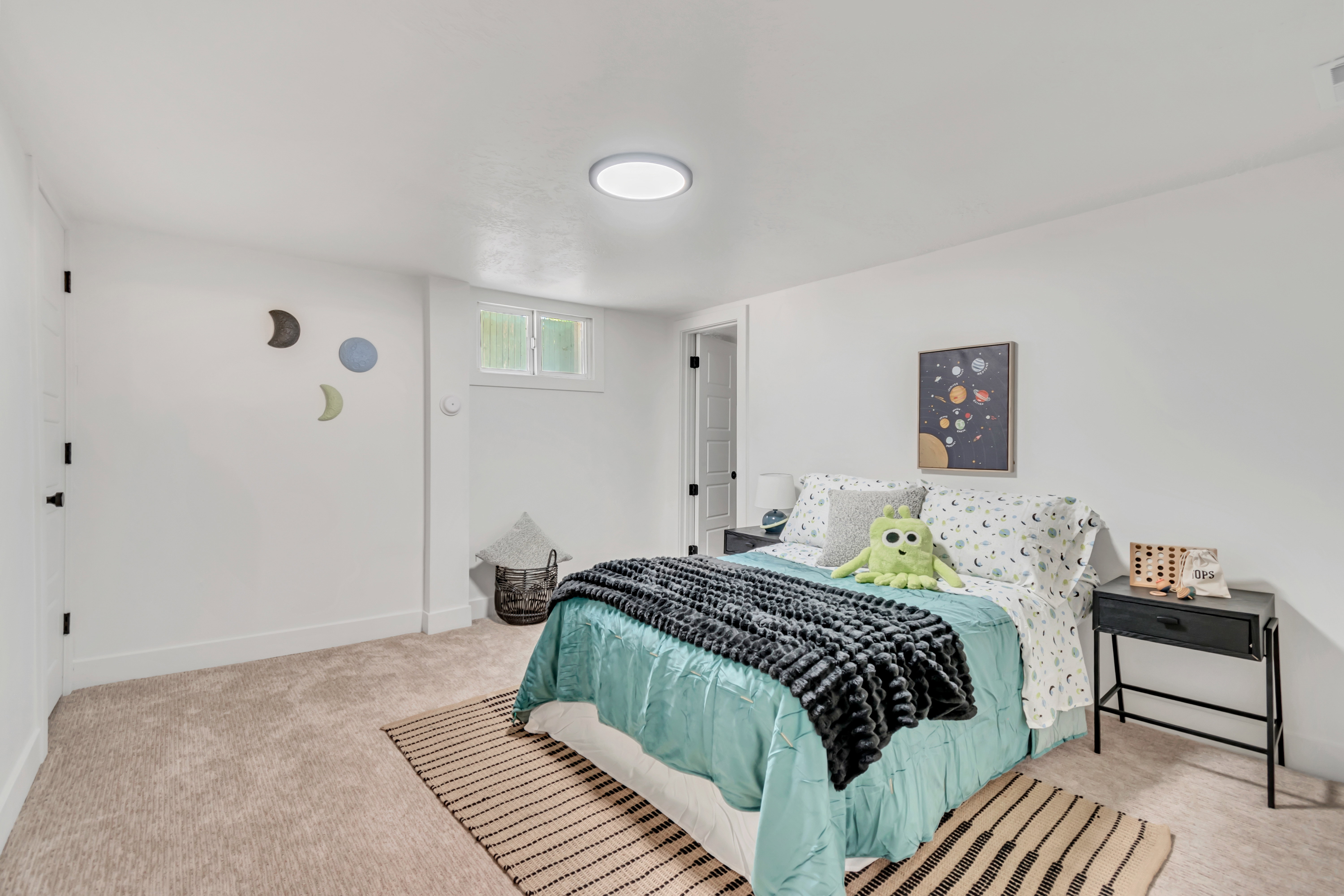 Bedroom featuring neutral carpeting, white walls, and a single window