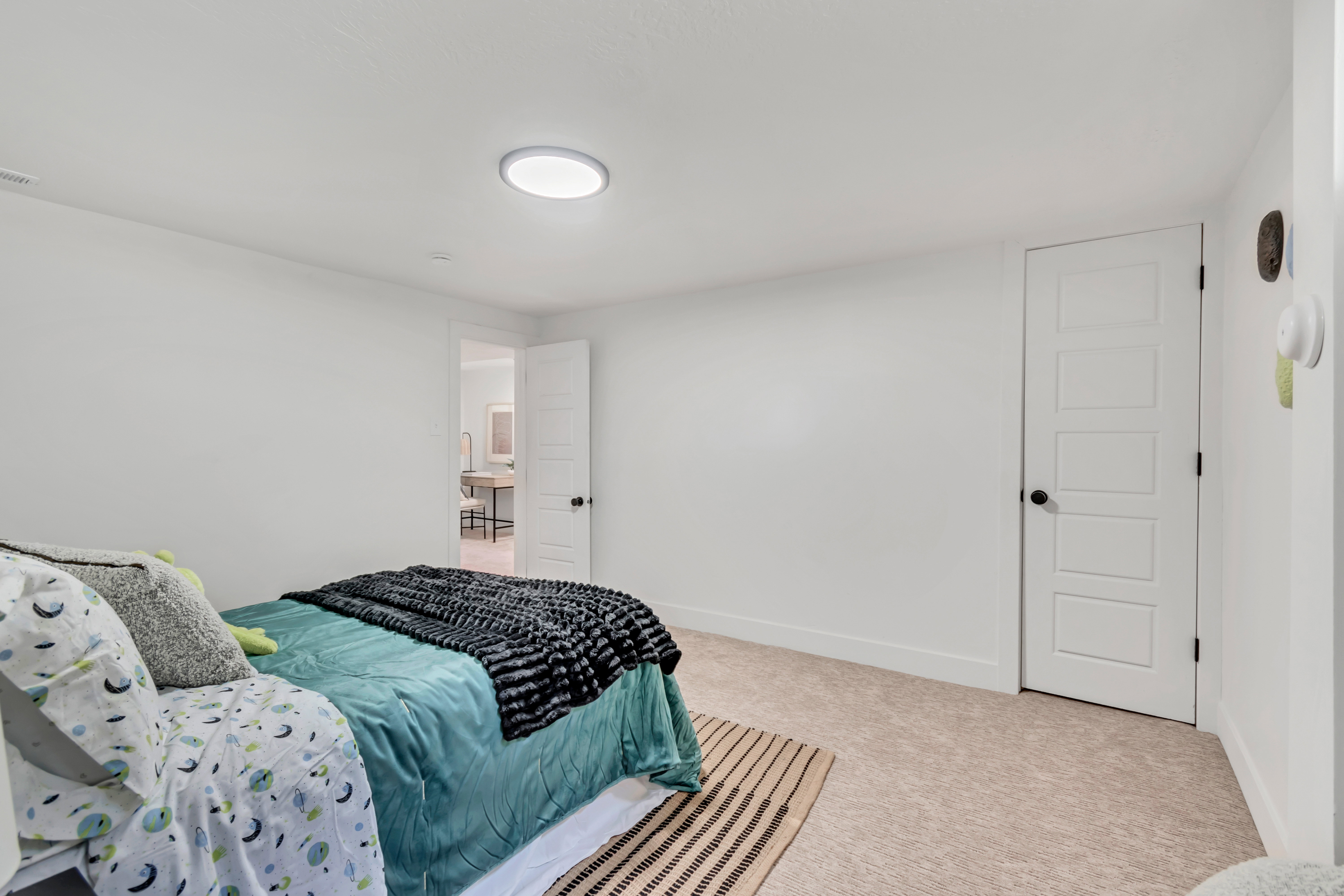 Room featuring light-colored carpeting and white baseboards