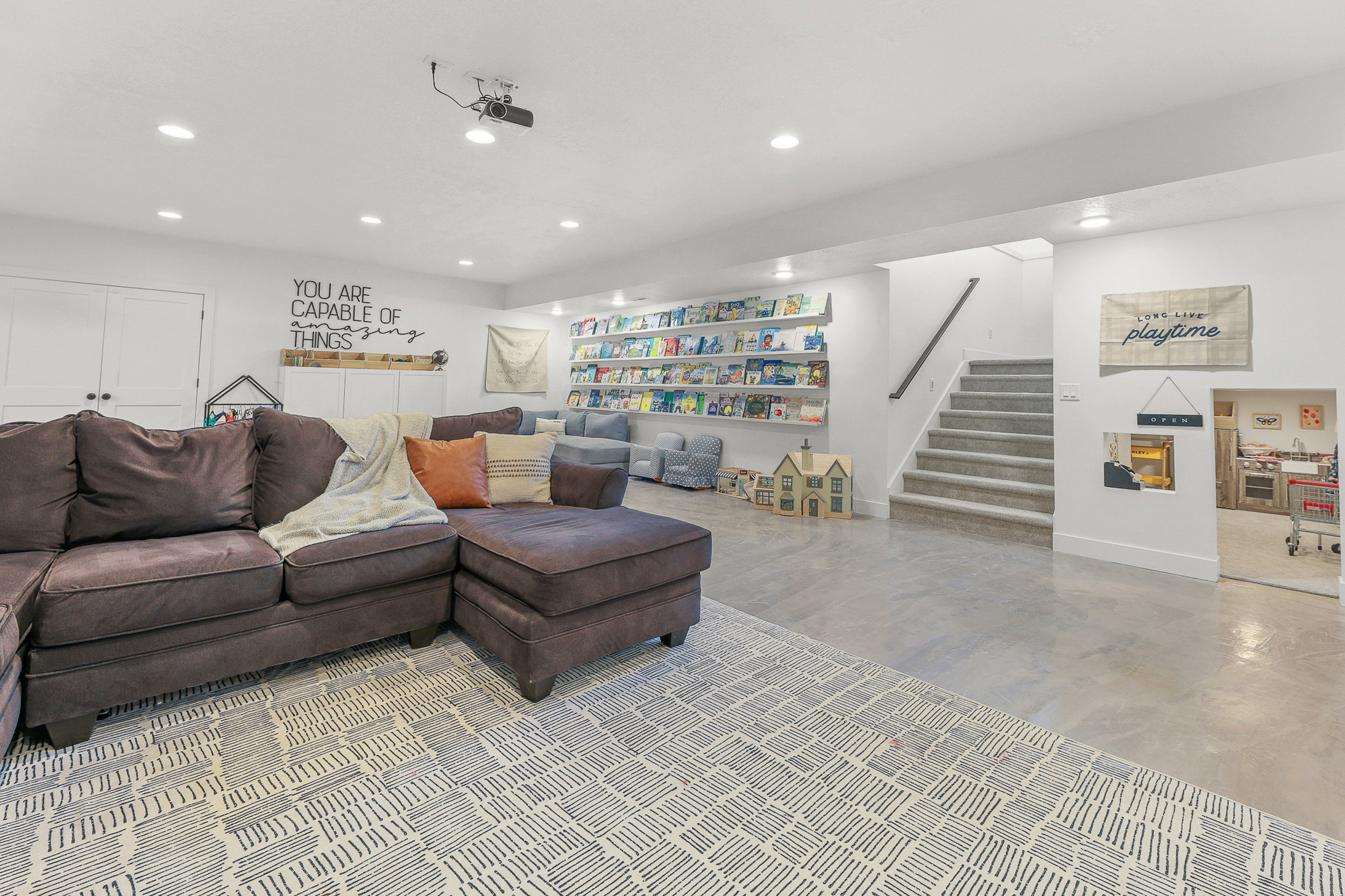 Spacious recreation room featuring recessed lighting and concrete flooring