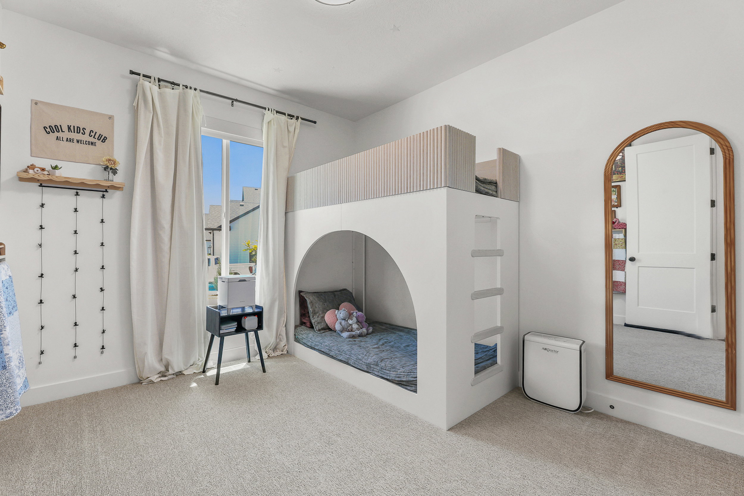 Built-in bunk bed structure with an arched lower bunk