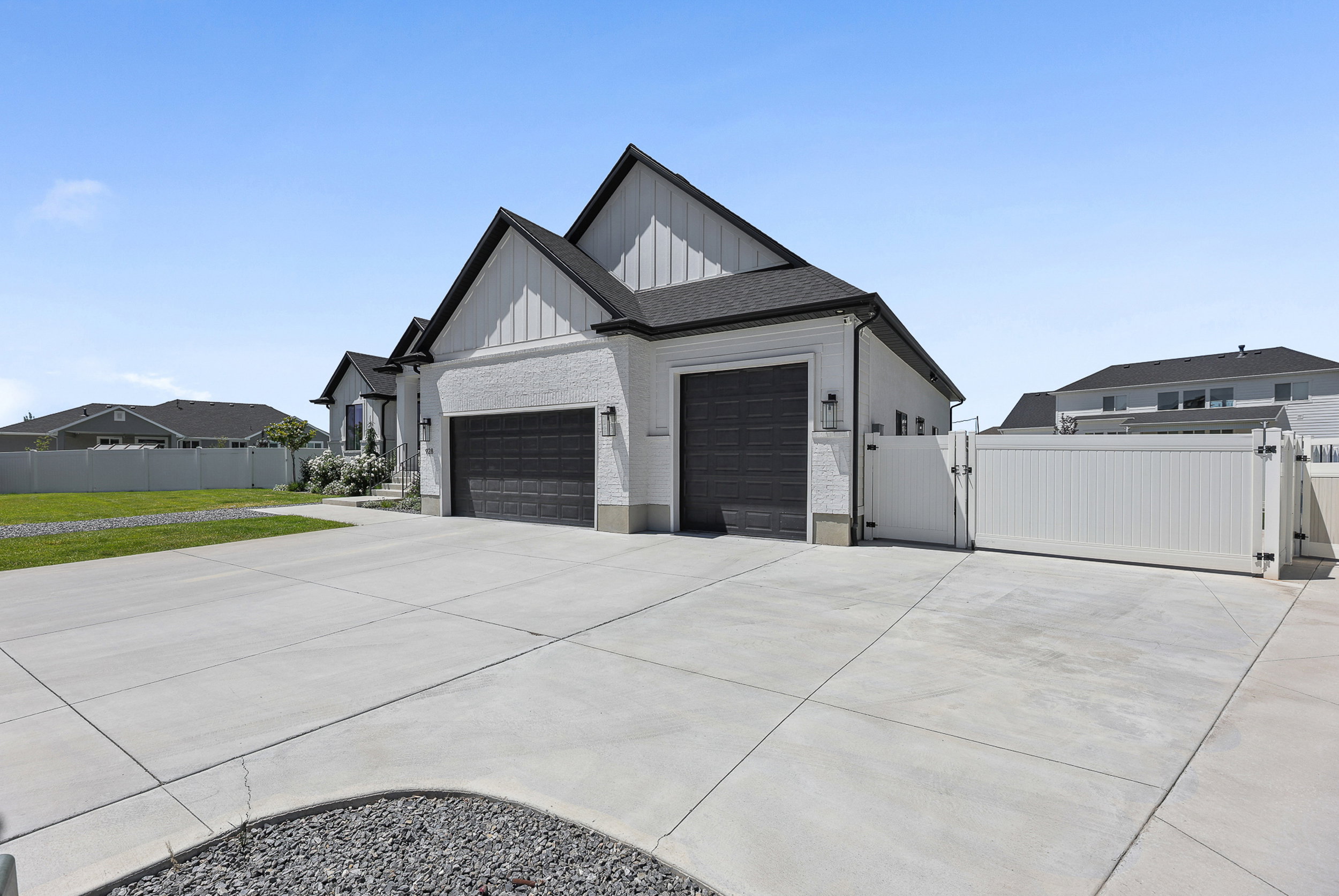 Contemporary exterior featuring white stucco and vertical siding accents