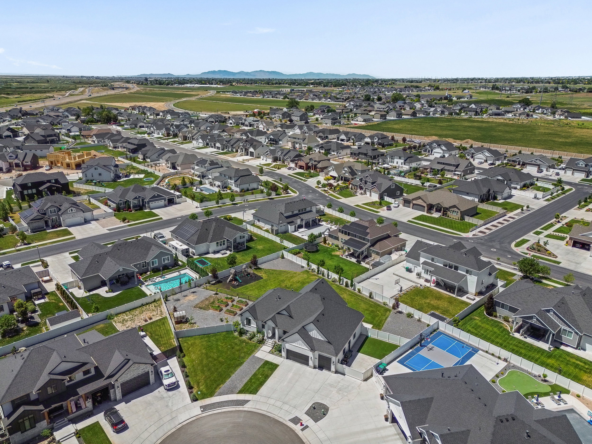 Aerial perspective of a developed residential community with diverse home exteriors