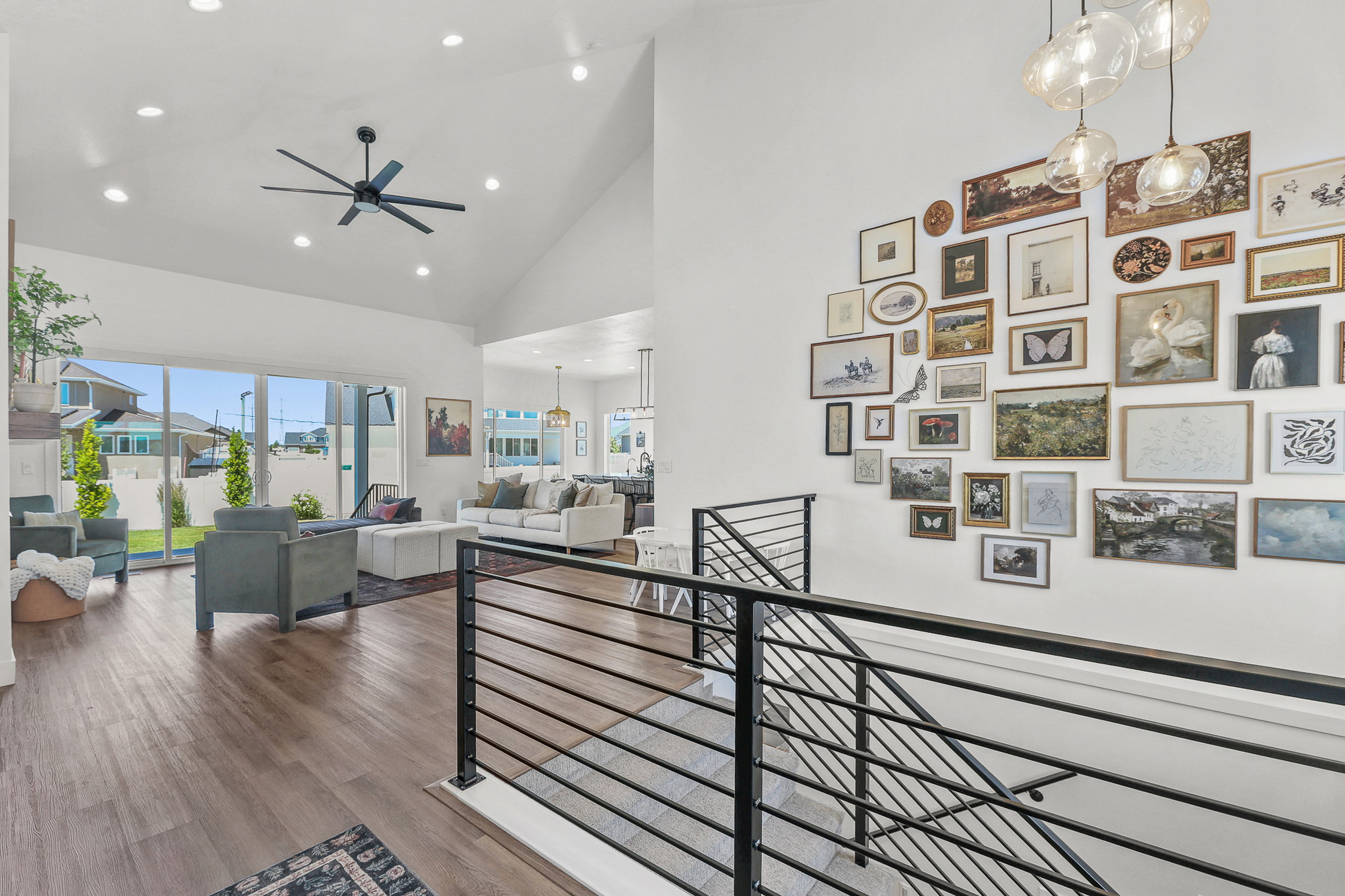 Spacious living area featuring high vaulted ceilings, recessed lighting, and wood-finish flooring