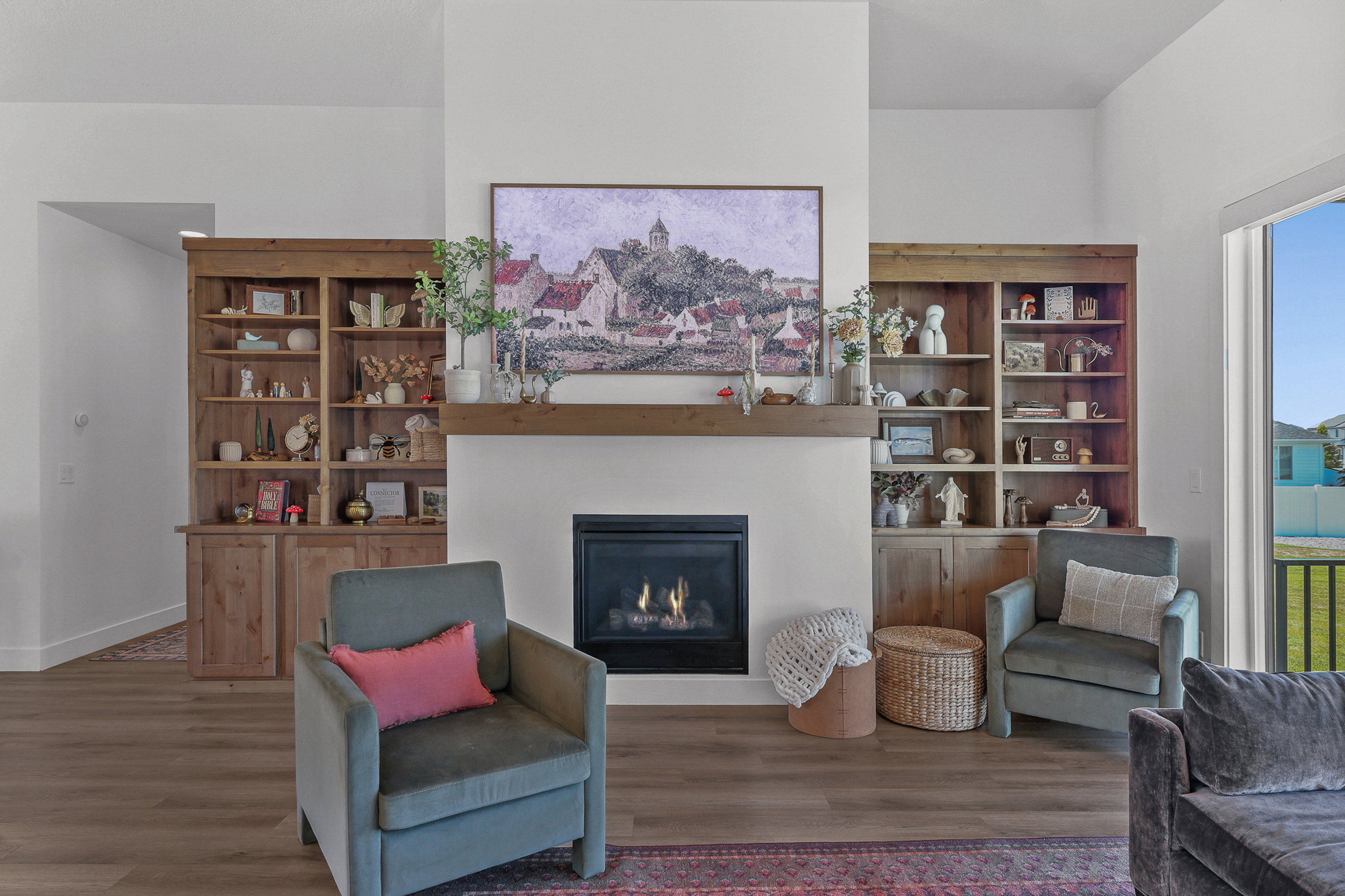 Fireplace featuring a wooden mantle and hearth, flanked by built-in wood cabinetry with open shelving and lower storage