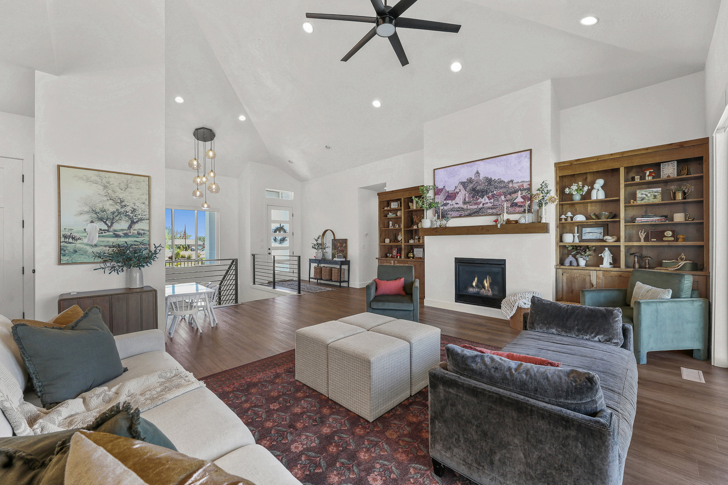 Vaulted ceilings with recessed lighting and a ceiling fan enhance this living space