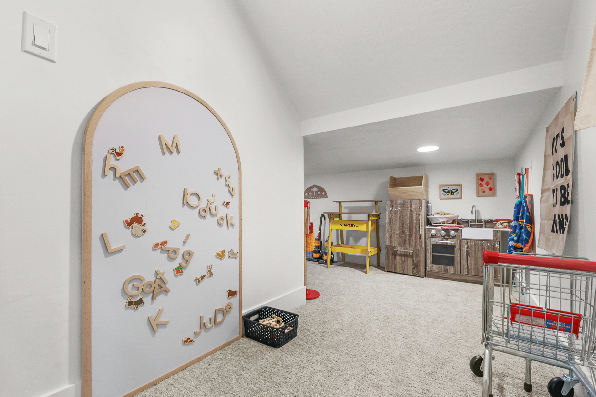 Carpeted room with a built-in arched whiteboard, recessed lighting, and a white wall finish