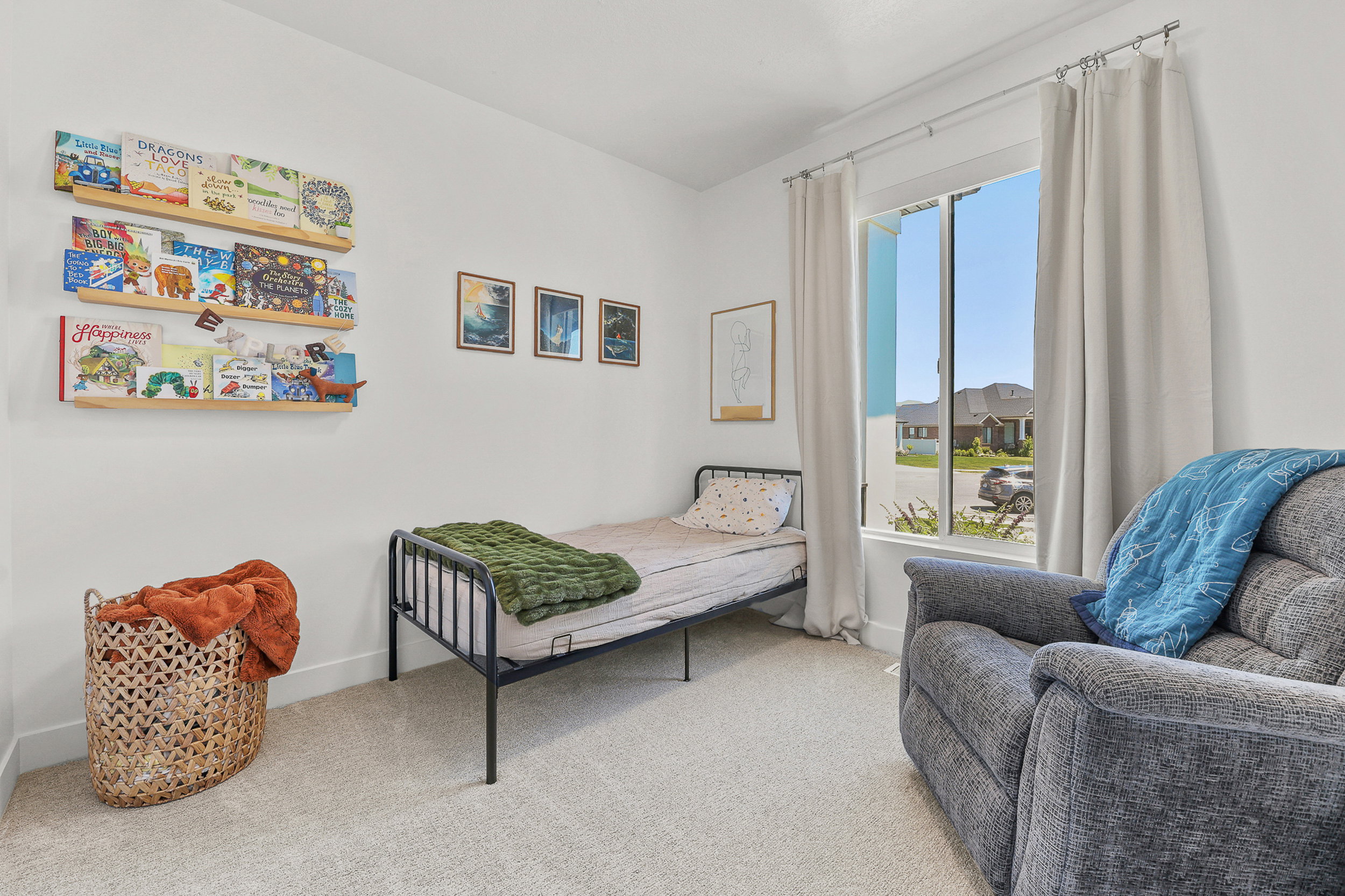 Bright room featuring neutral carpeting and white walls
