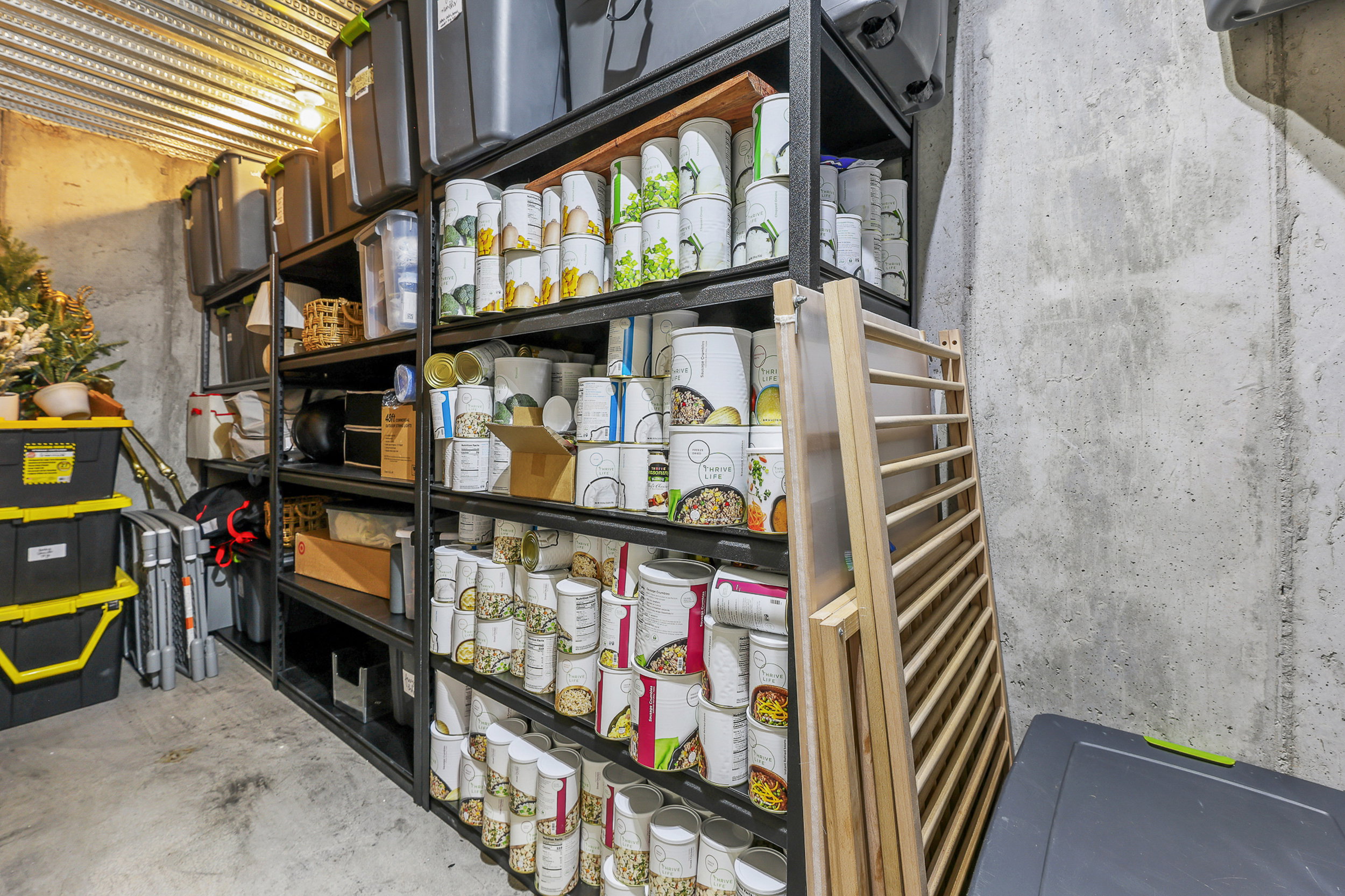 Utility area featuring concrete walls, a concrete floor, and an exposed metal ceiling