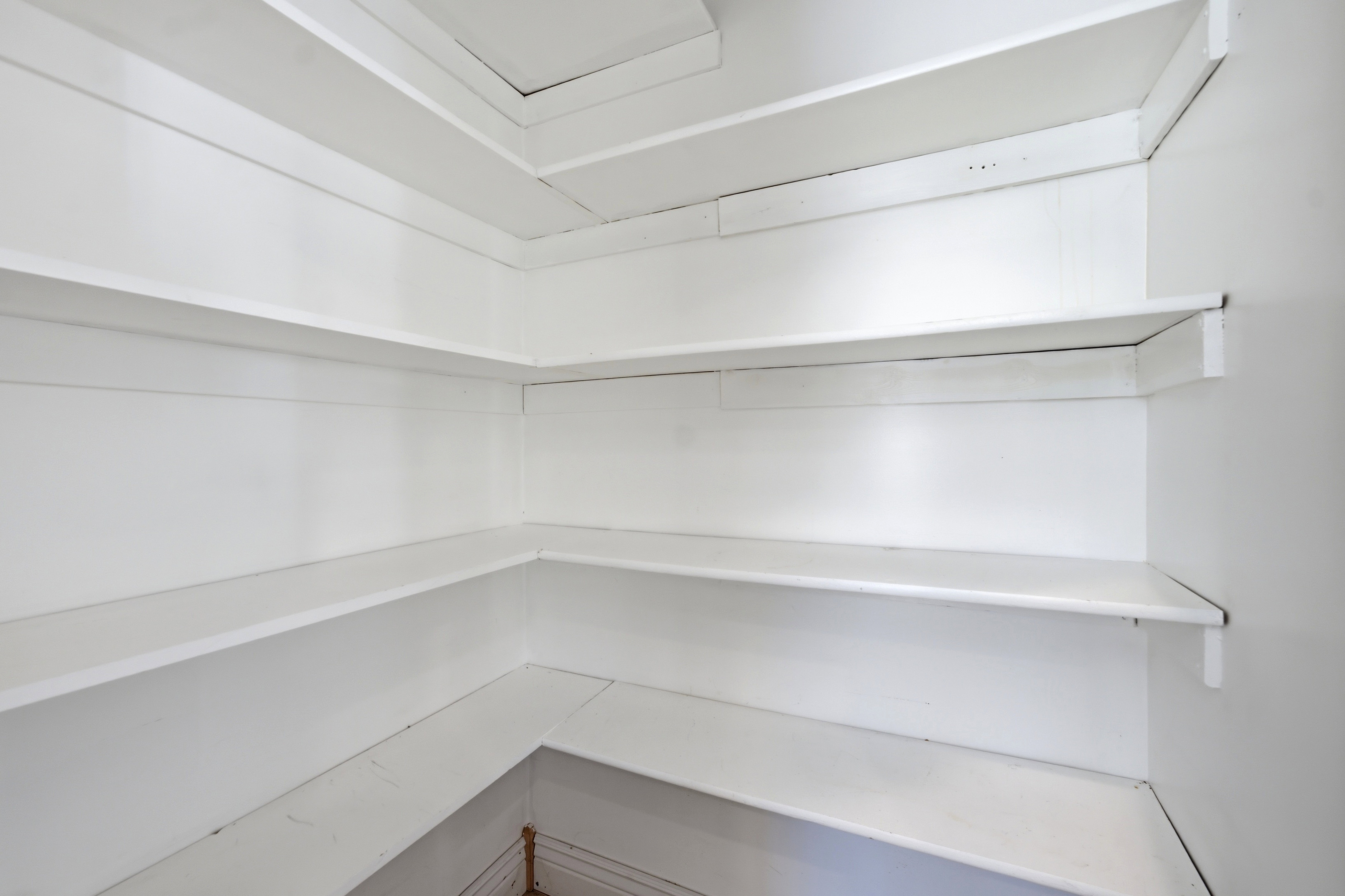 White shelving units providing extensive storage