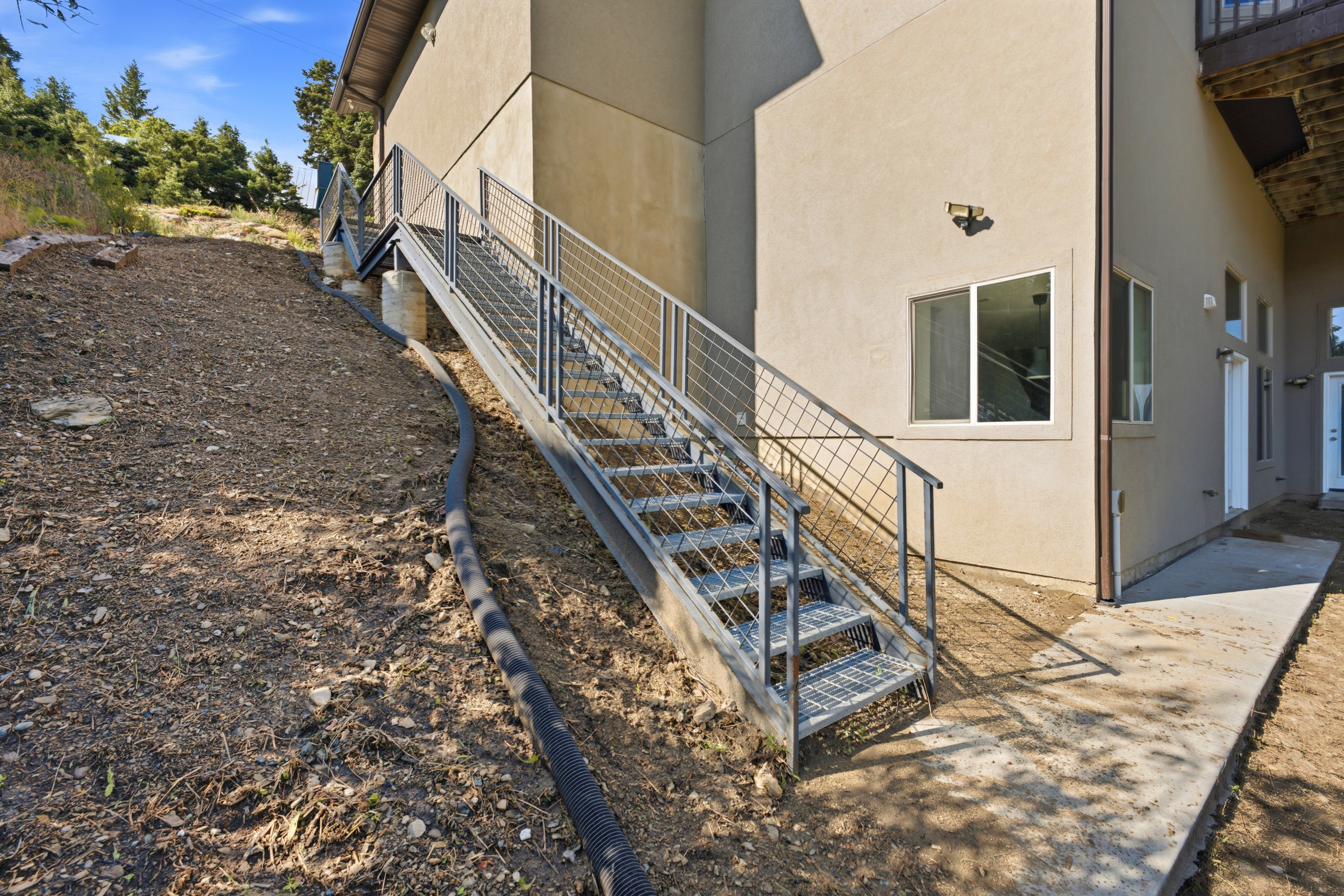 Side of the house and stairs to access the ADU externally.