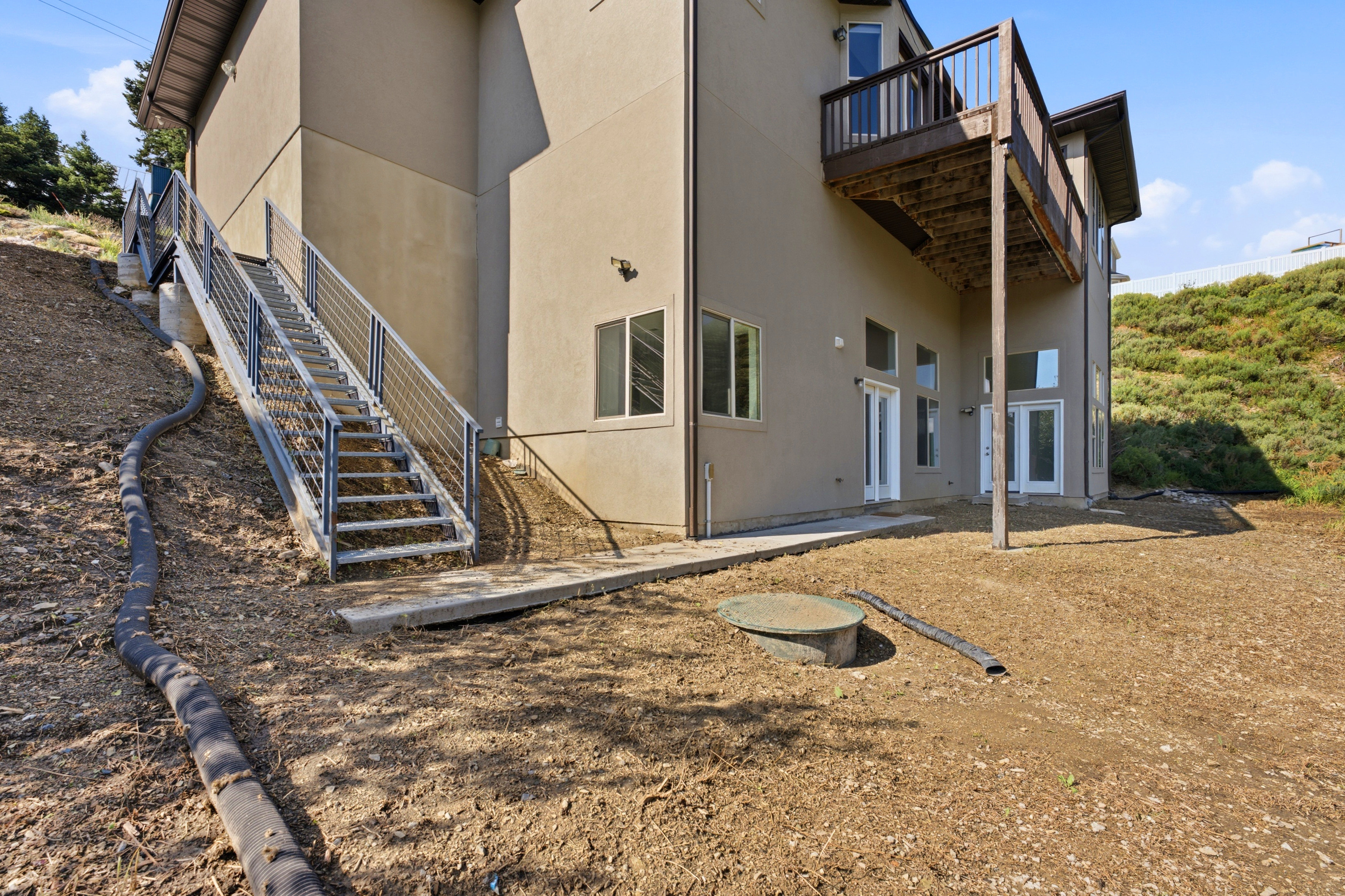 Side of the house and stairs to access the ADU externally.