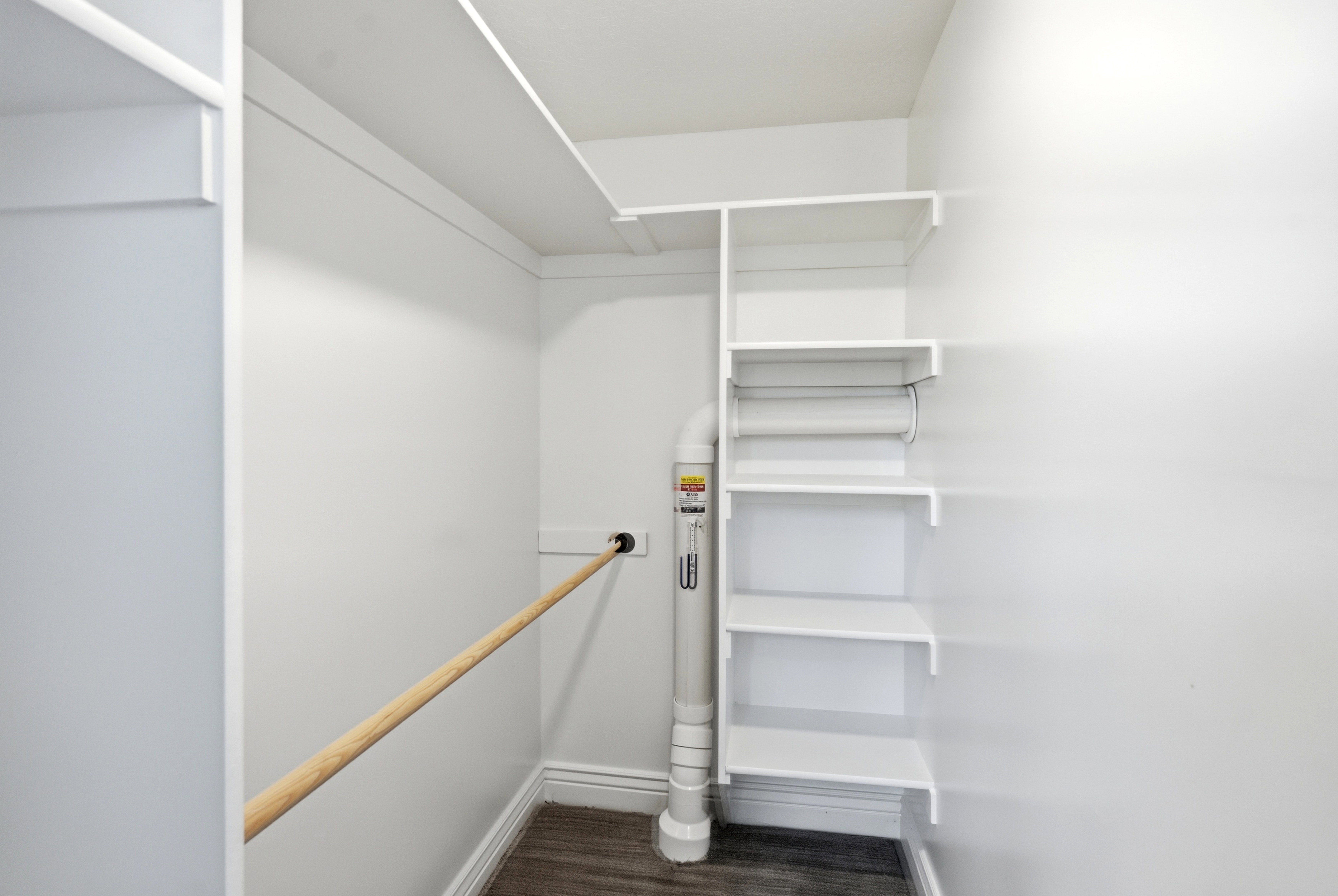 ADU Walk-in closet. The radon mitigation system is also visible (no noise).