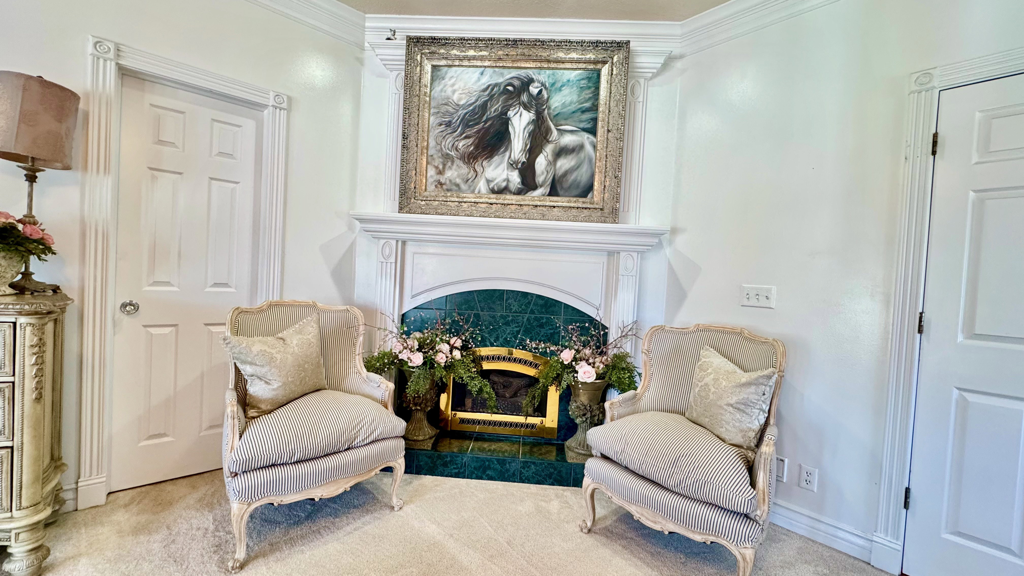 Fireplace featuring a decorative mantel, intricate trim, and a green tile surround