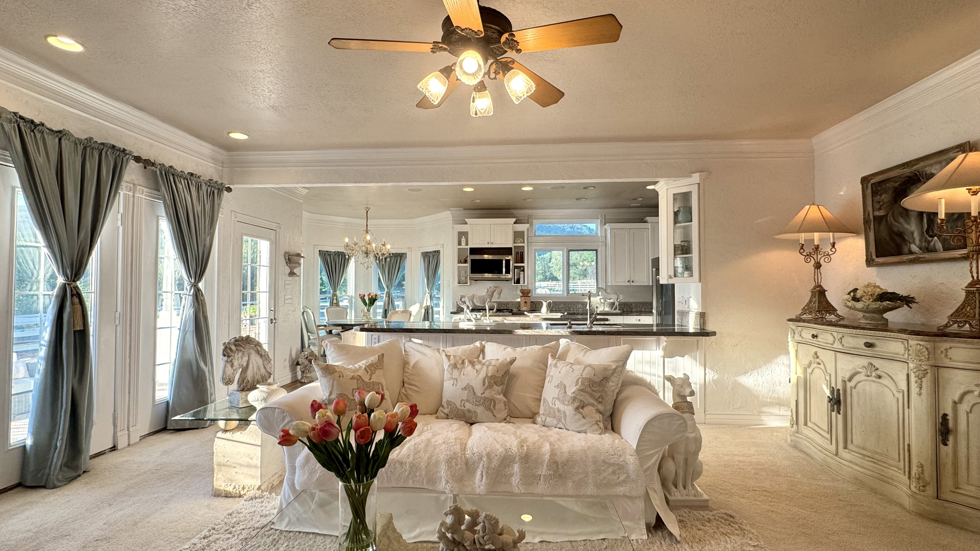 Living area with recessed lighting, wood-finish ceiling fan, and crown molding