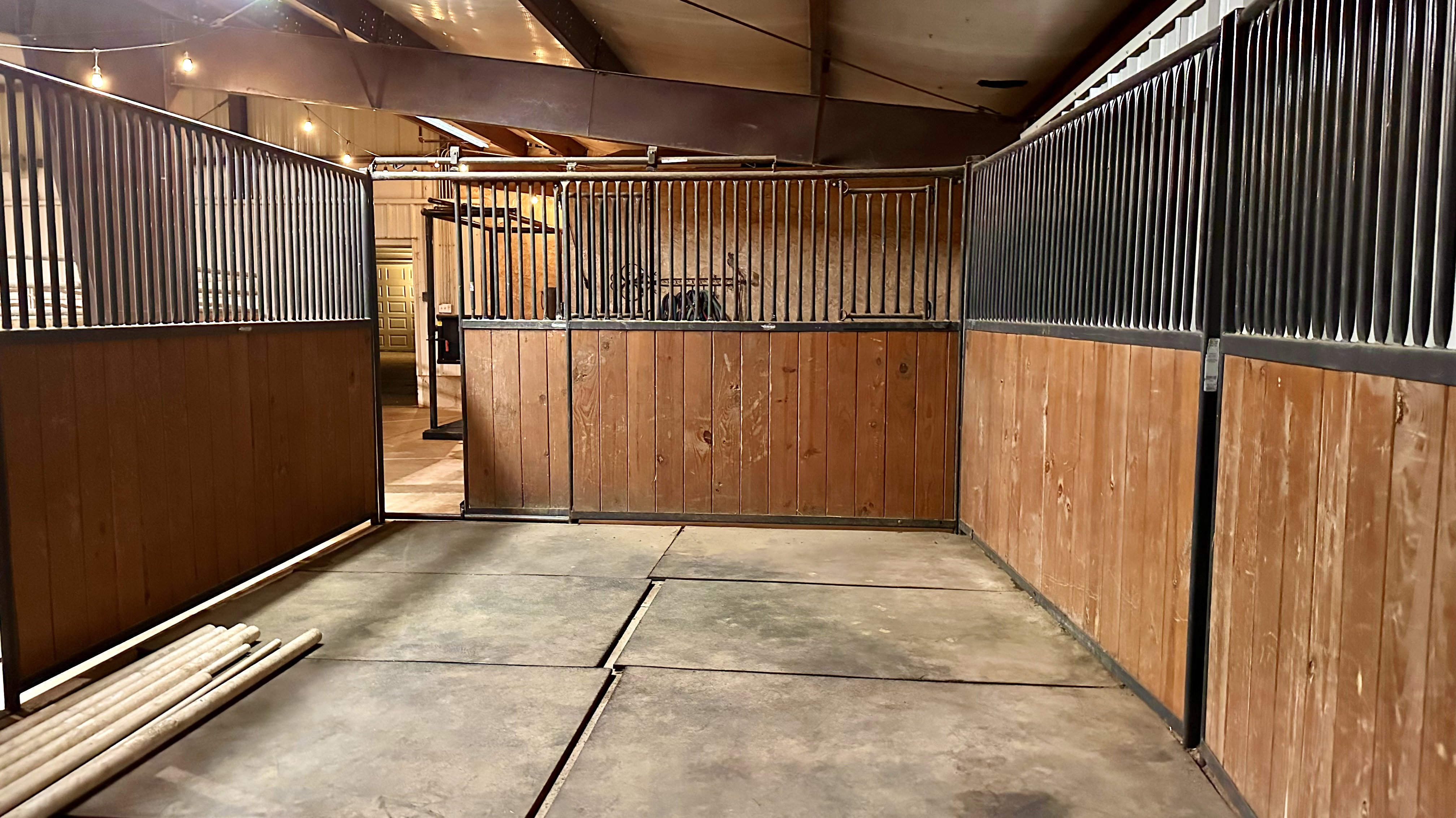 Interior stall space featuring wood paneling and metal bar upper sections