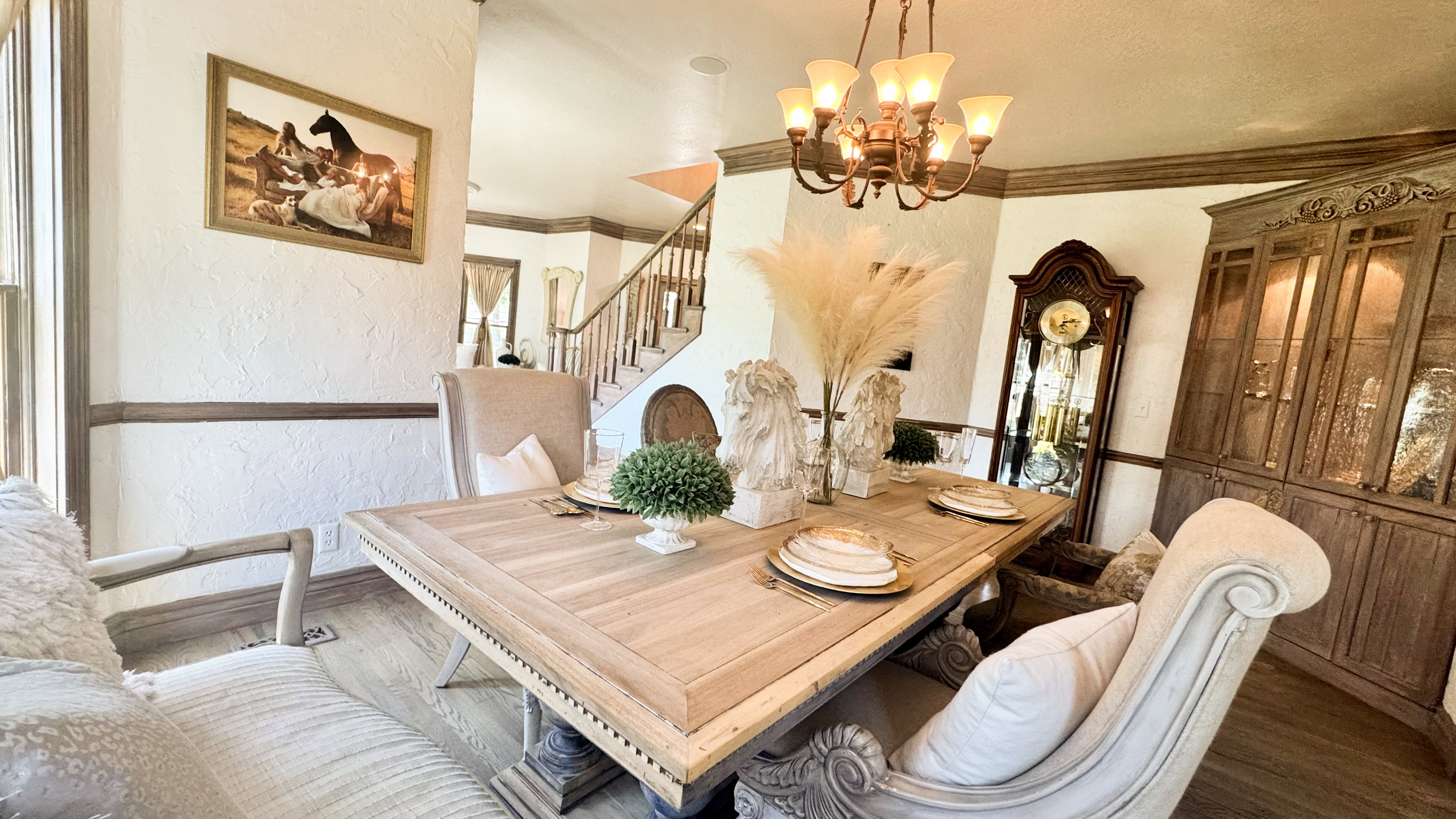 Formal dining area featuring a wood-finish table, chandelier lighting, and hardwood flooring