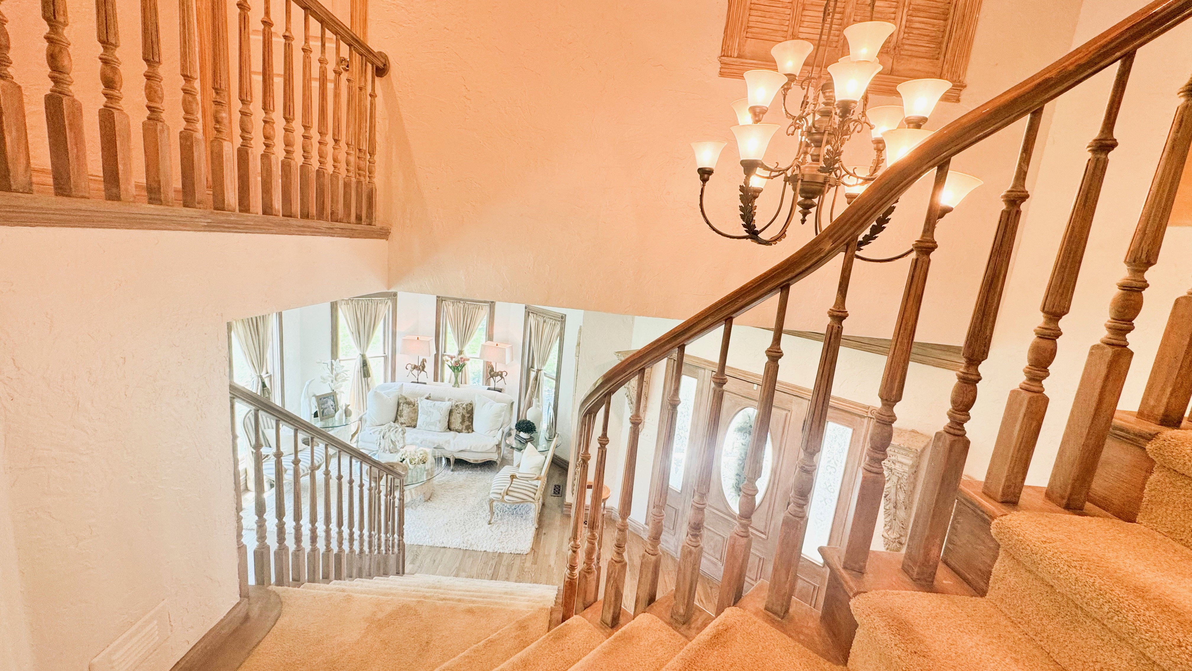 Grand staircase with wood balusters and carpeted treads