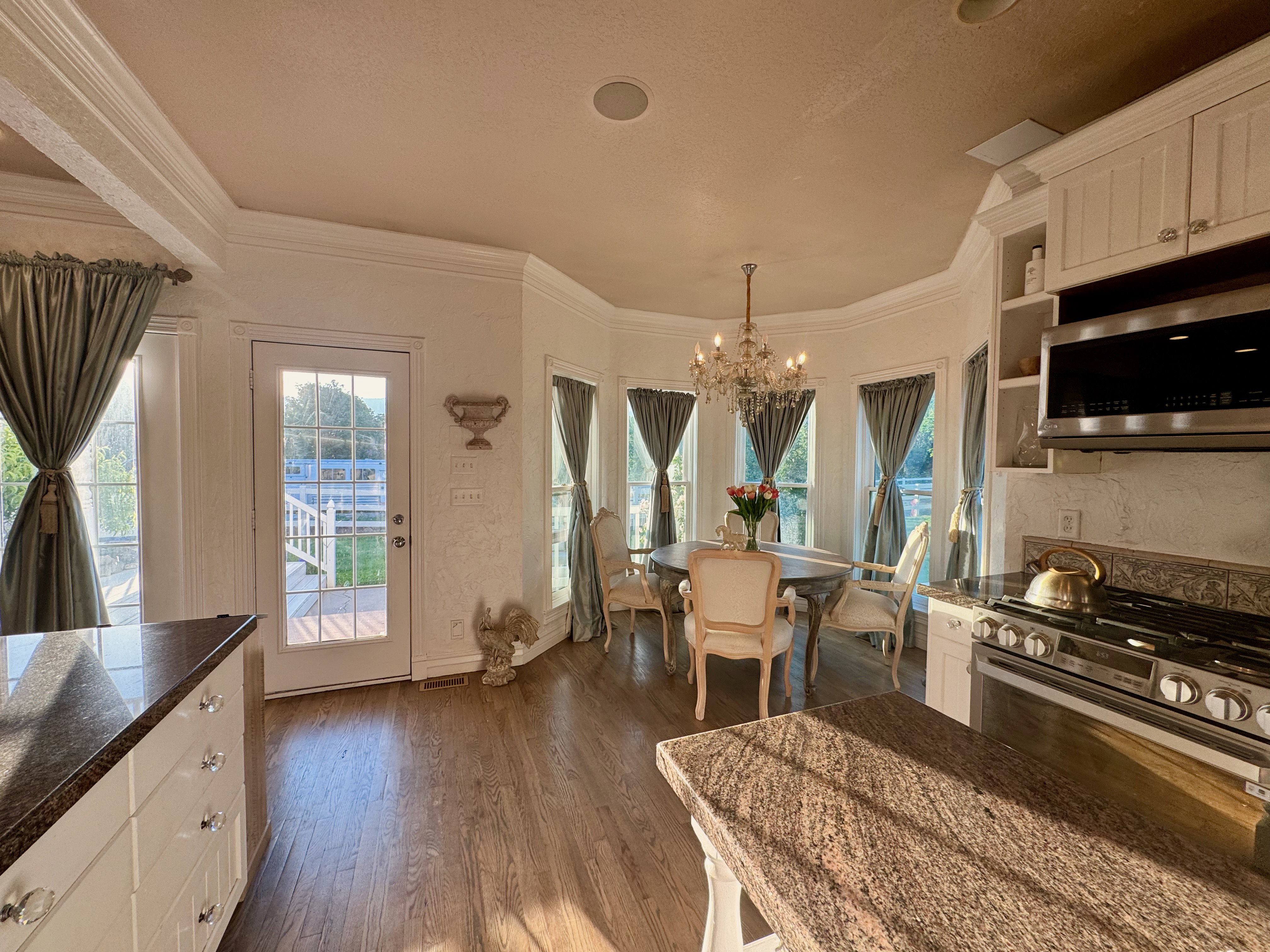 Expansive kitchen and dining area with wood-finish flooring