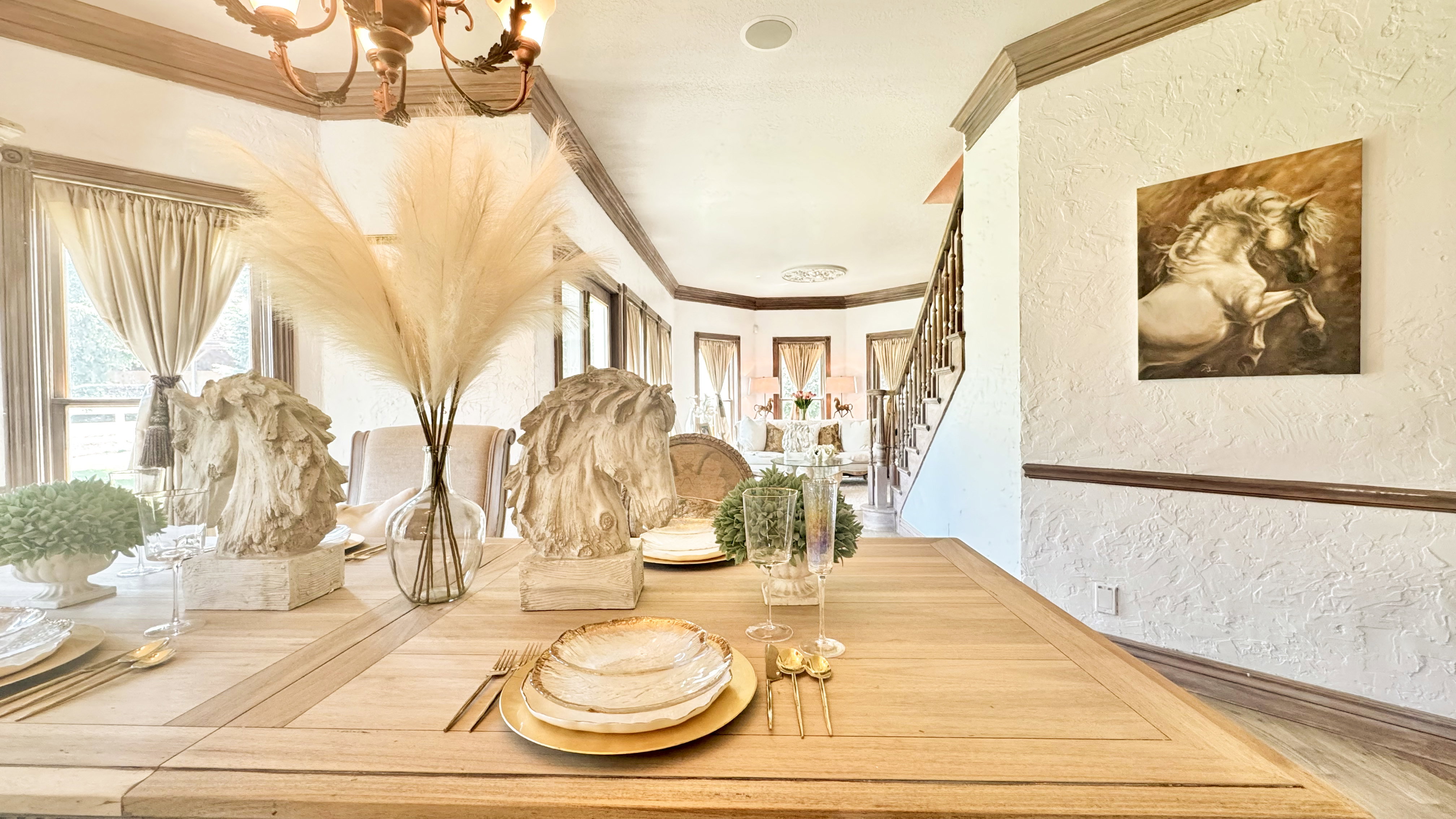 Formal dining area featuring wood-finish flooring, bay windows, and a classic chandelier