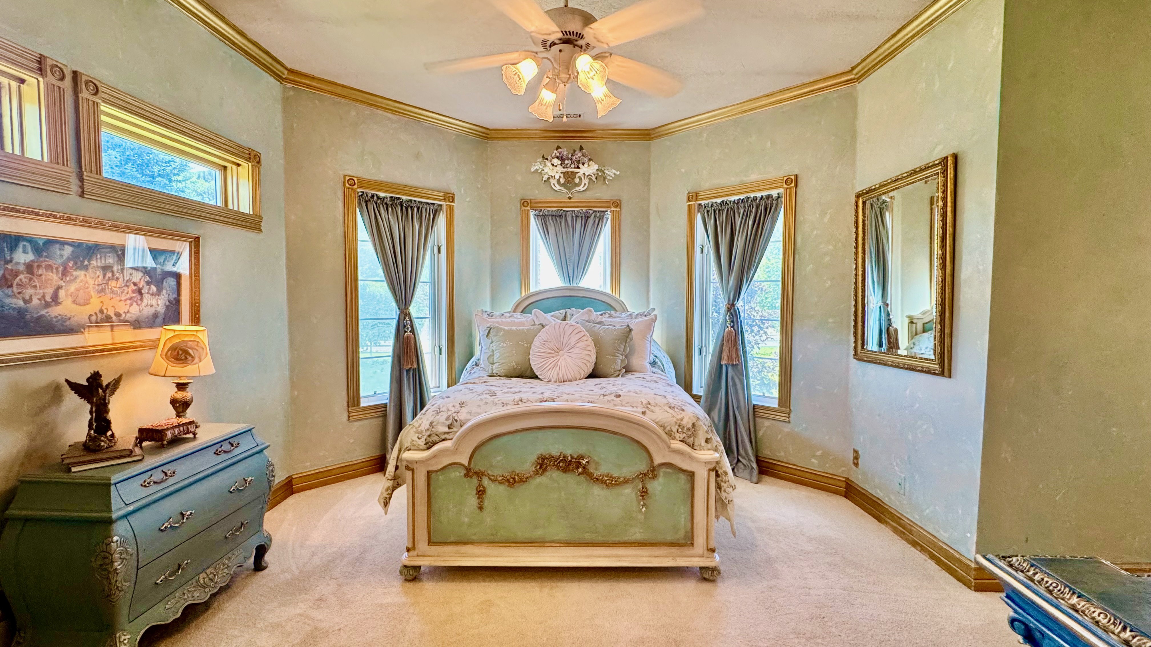 Carpeted room featuring elegant gold-toned crown molding and baseboards