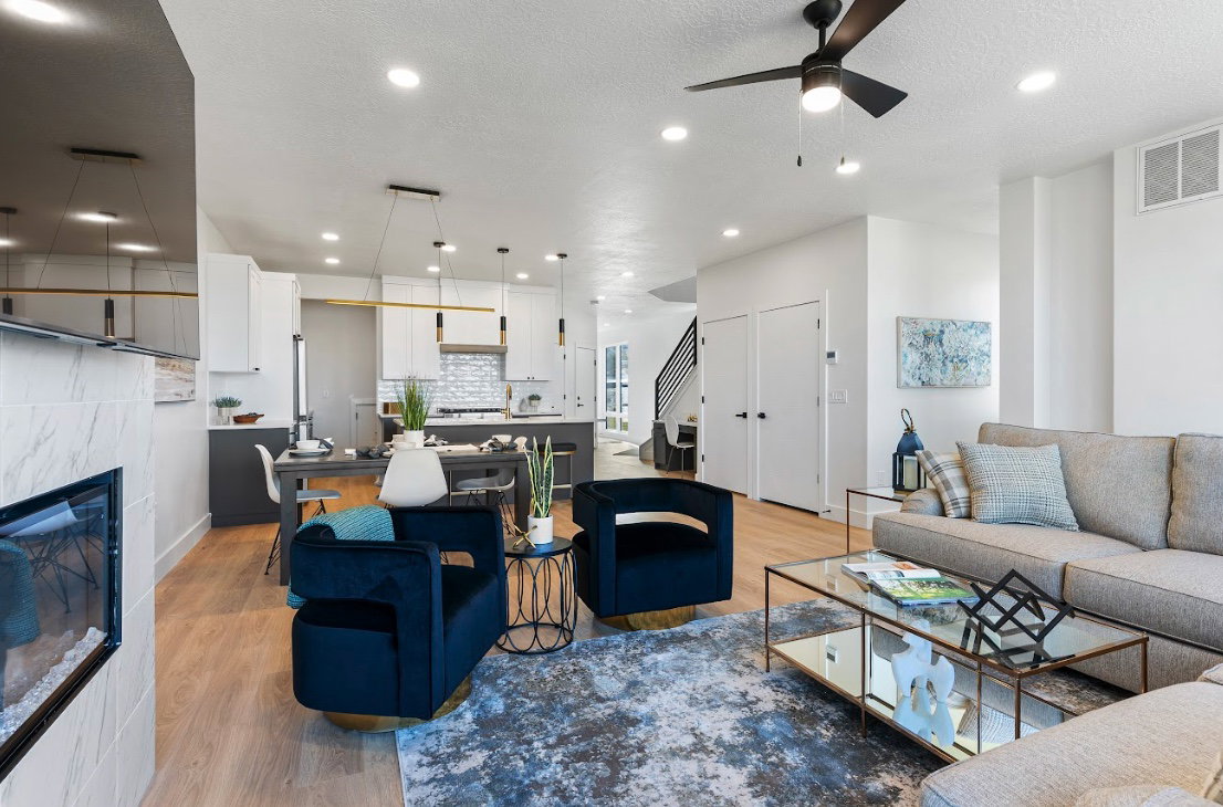 Open-concept living space featuring wood-finish flooring, recessed lighting, and a modern ceiling fan