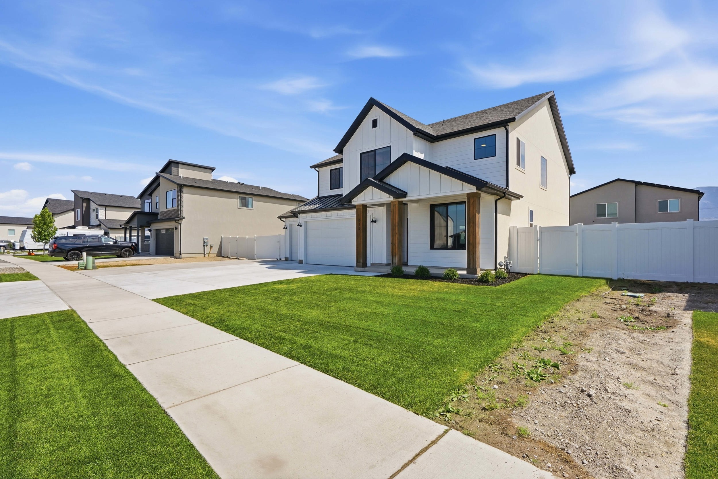 Contemporary two-story residence featuring a white board-and-batten facade and dark trim accents