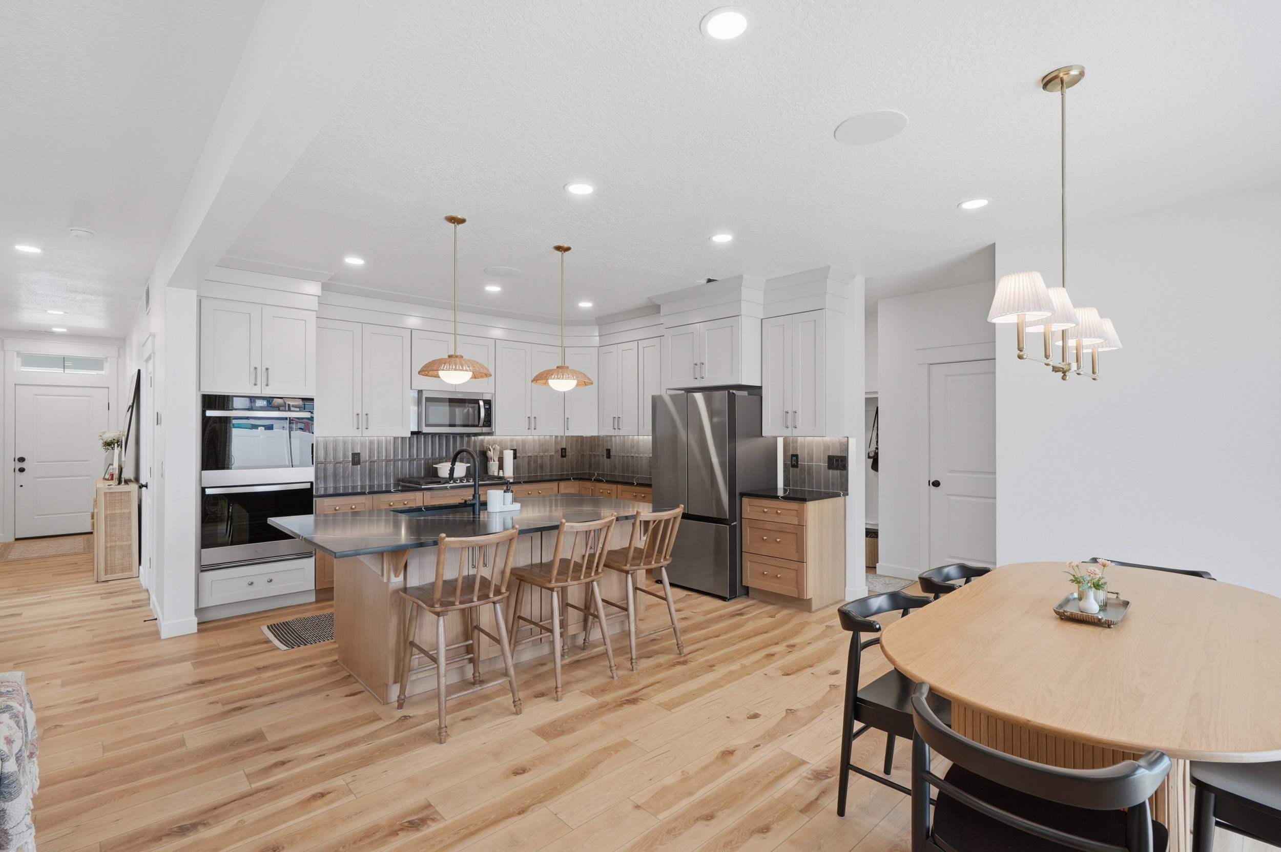 Open-concept kitchen and dining area featuring light wood-finish flooring