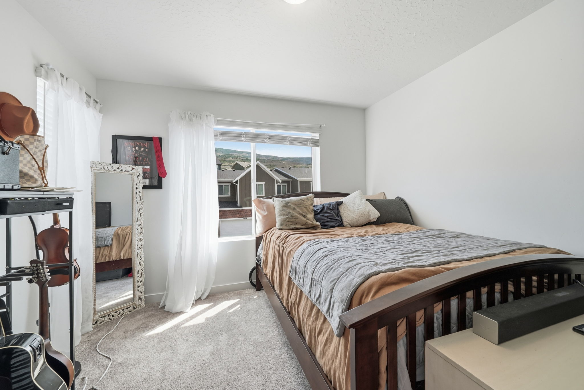 Carpeted room featuring a large window, white walls, and a recessed ceiling light