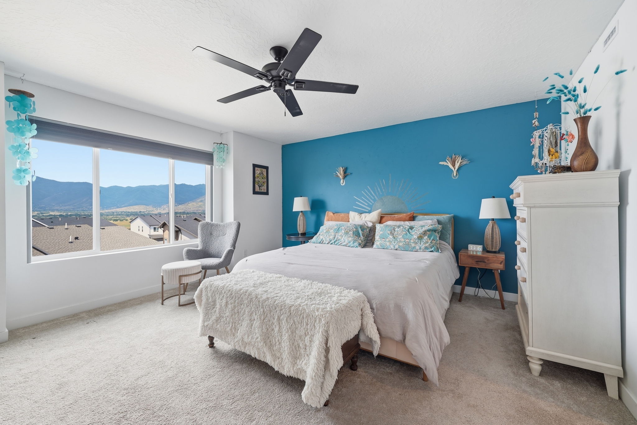 Expansive window framing distant mountains and rooftops