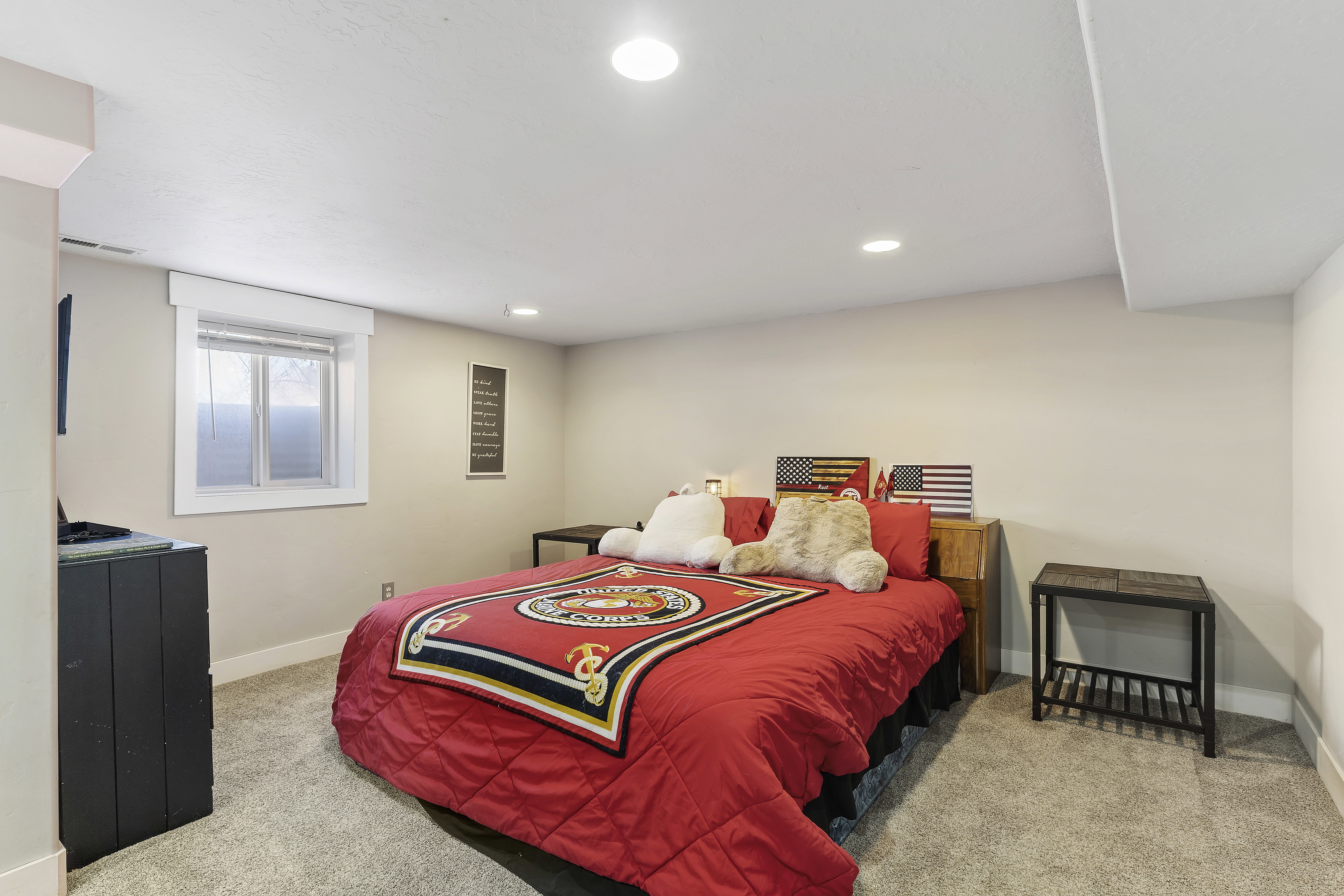 Carpeted room with recessed lighting and a window featuring horizontal blinds