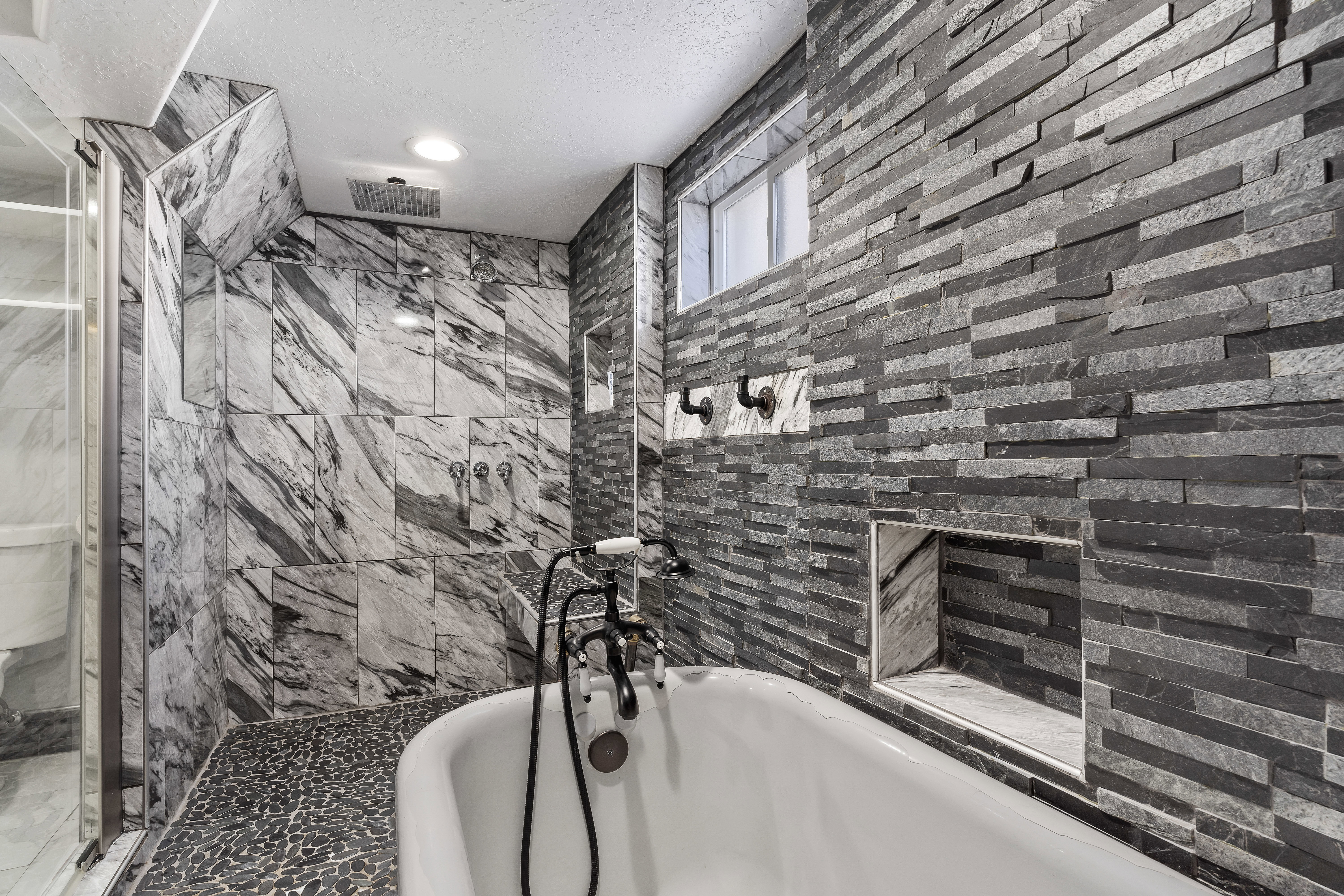 Freestanding soaking tub with black fixture