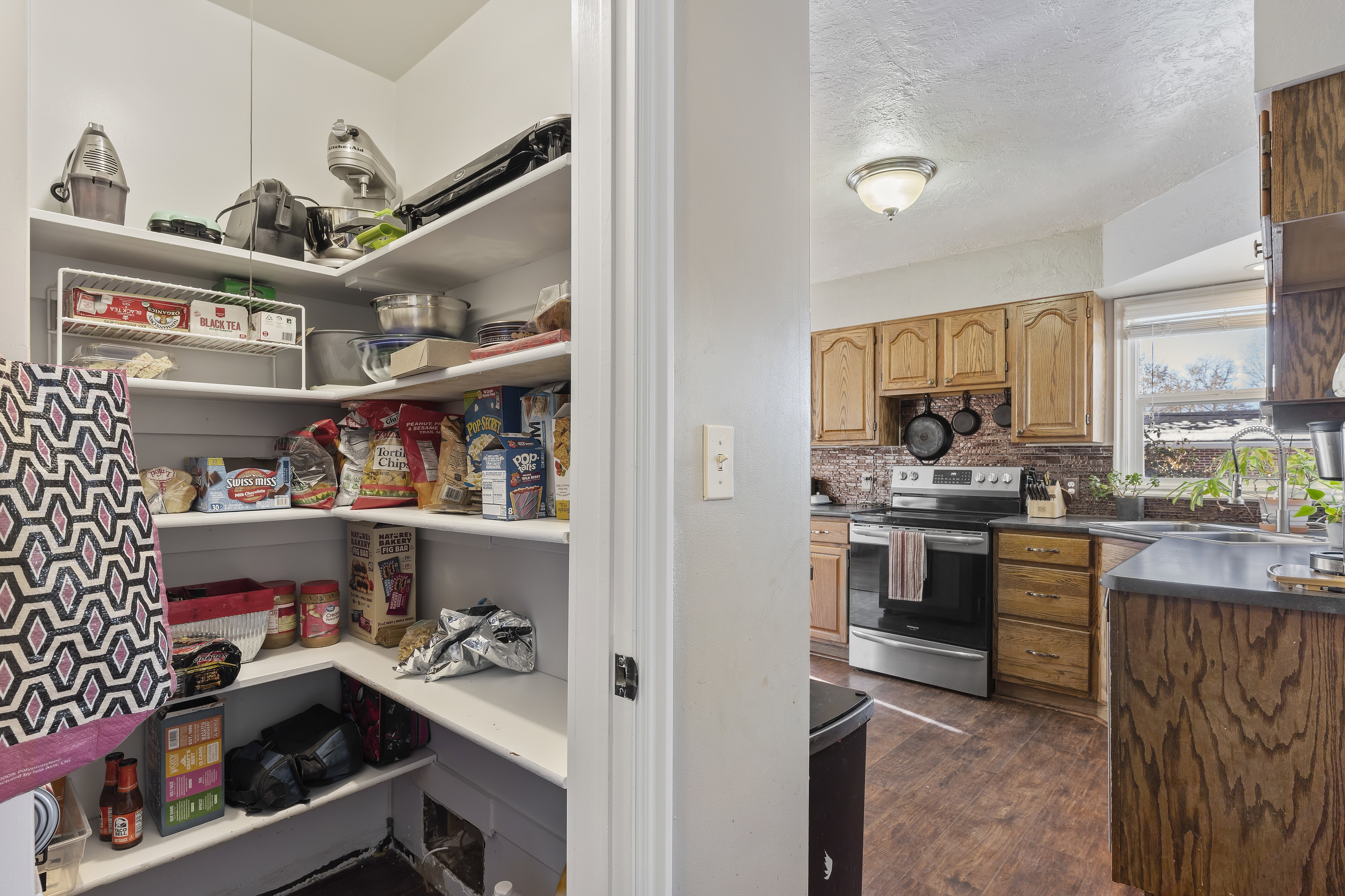 Kitchen pantry featuring wrap-around shelving