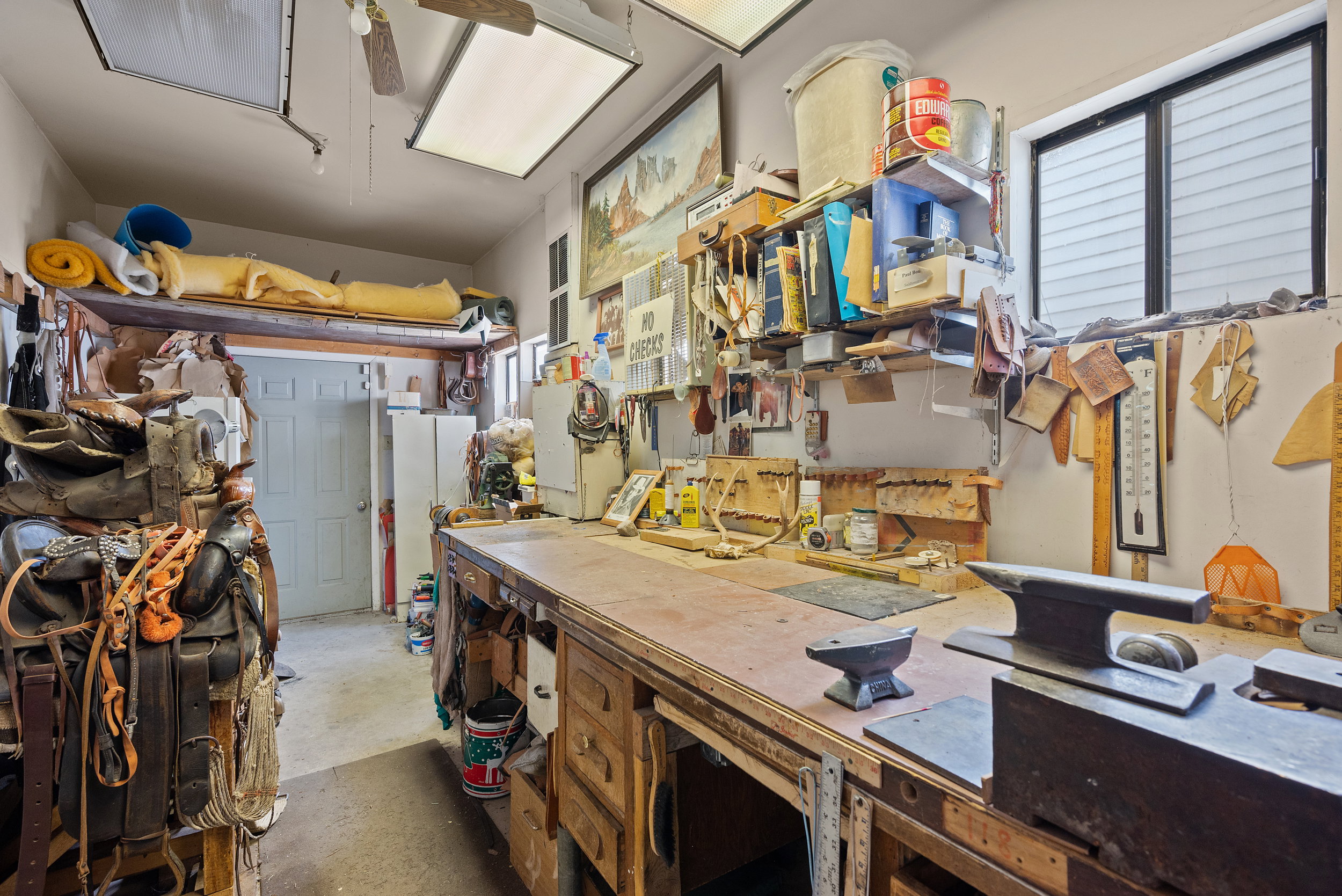 Dedicated workshop space featuring a long wooden workbench with built-in storage drawers.
