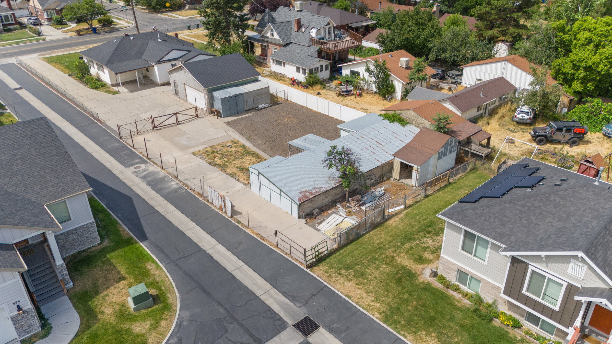 Aerial perspective showcasing multiple residential structures and surrounding grounds