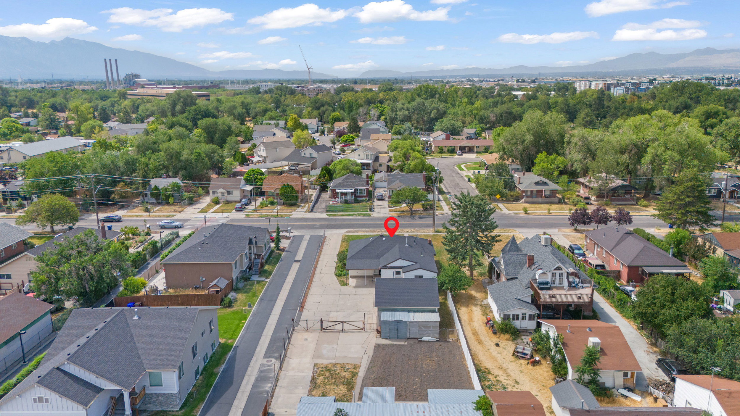 Aerial perspective of a neighborhood featuring mature trees and established residential properties
