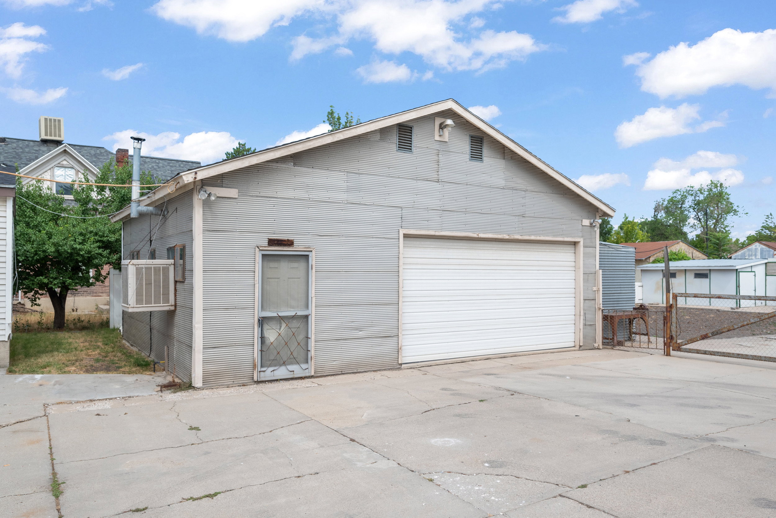 Detached garage structure with a single garage door and an exterior workshop entry door