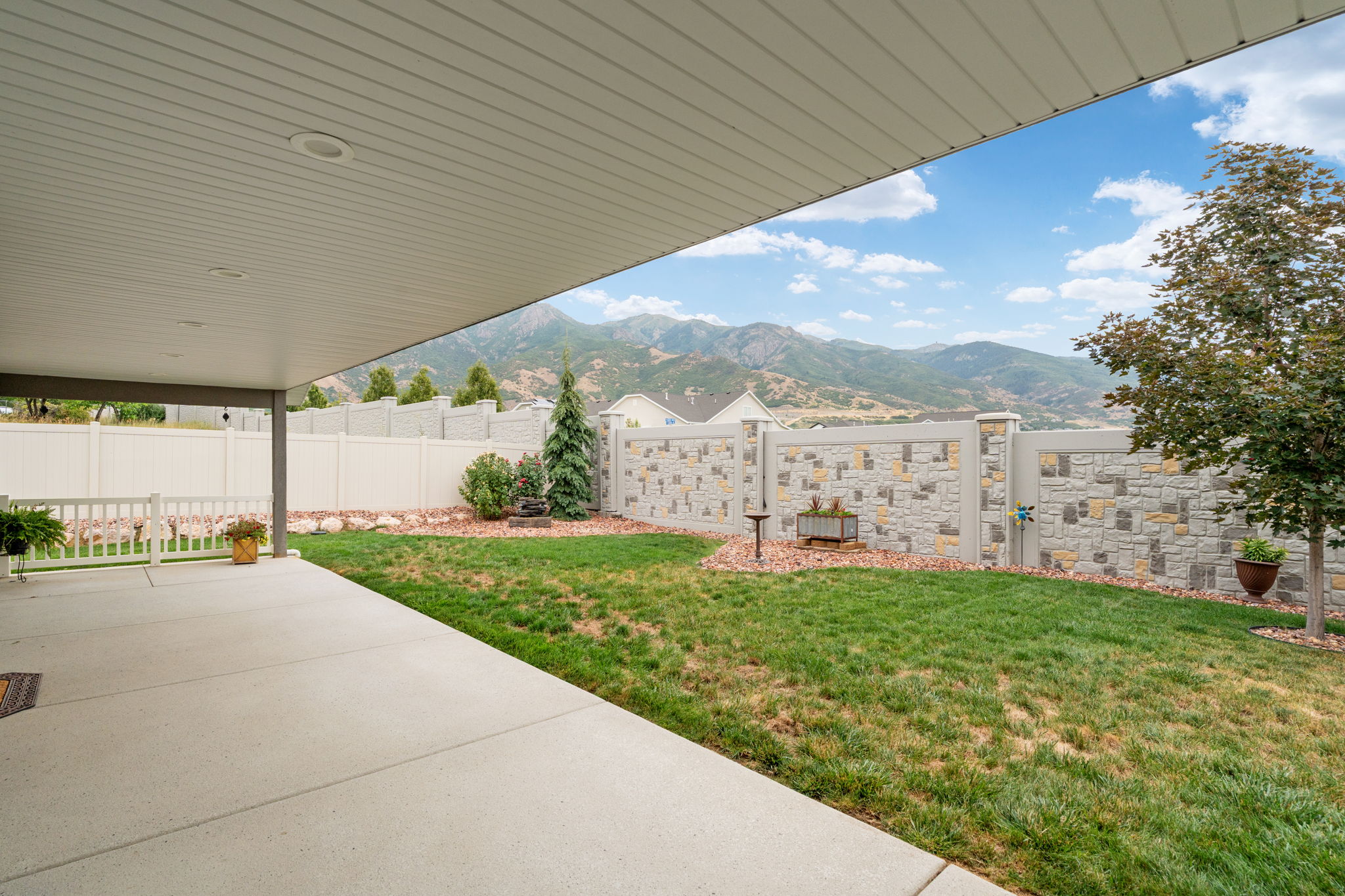Covered patio featuring recessed lighting, a concrete slab, and a white railing