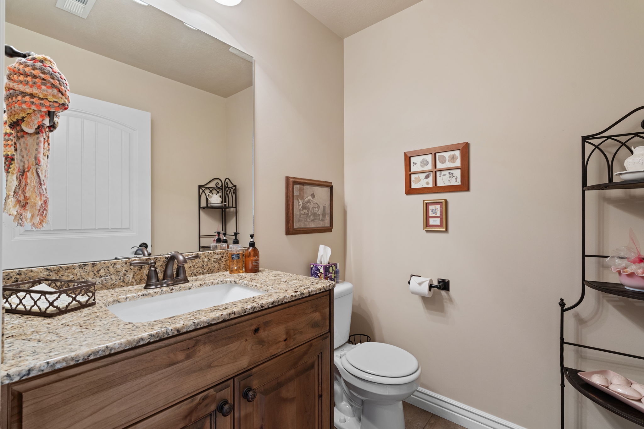 Bathroom vanity with an integrated sink, a speckled countertop, and a dark wood-finish cabinet with double doors