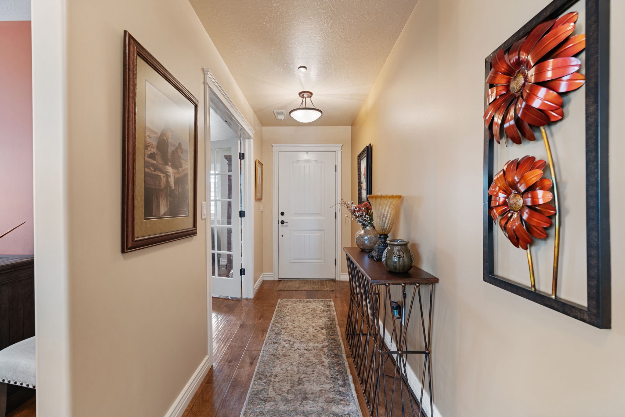 Inviting entryway featuring wood-finish flooring, neutral wall tones, and recessed lighting